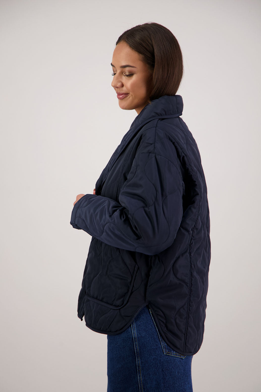 BESTSELLER. Chapman Quilted Jacket in Ink by Briarwood NZ. Quilted swirl design, high collar, side split detail, buttons front, stitched on pockets, slightly longer in the back, box fit, lined