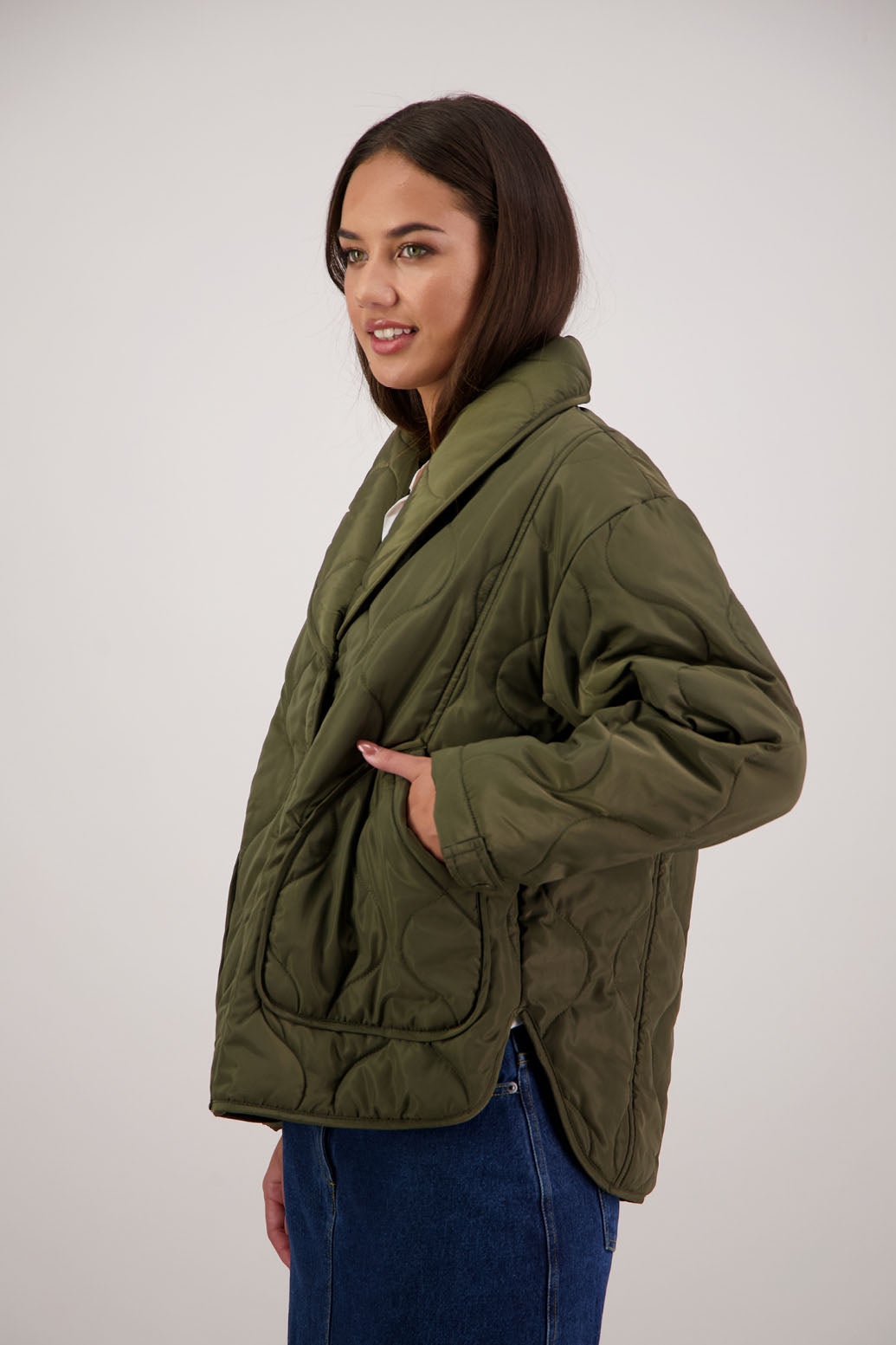BESTSELLER. Chapman Quilted Jacket in Khaki by Briarwood NZ. Quilted swirl design, high collar, side split detail, buttons front, stitched on pockets, slightly longer in the back, box fit, lined