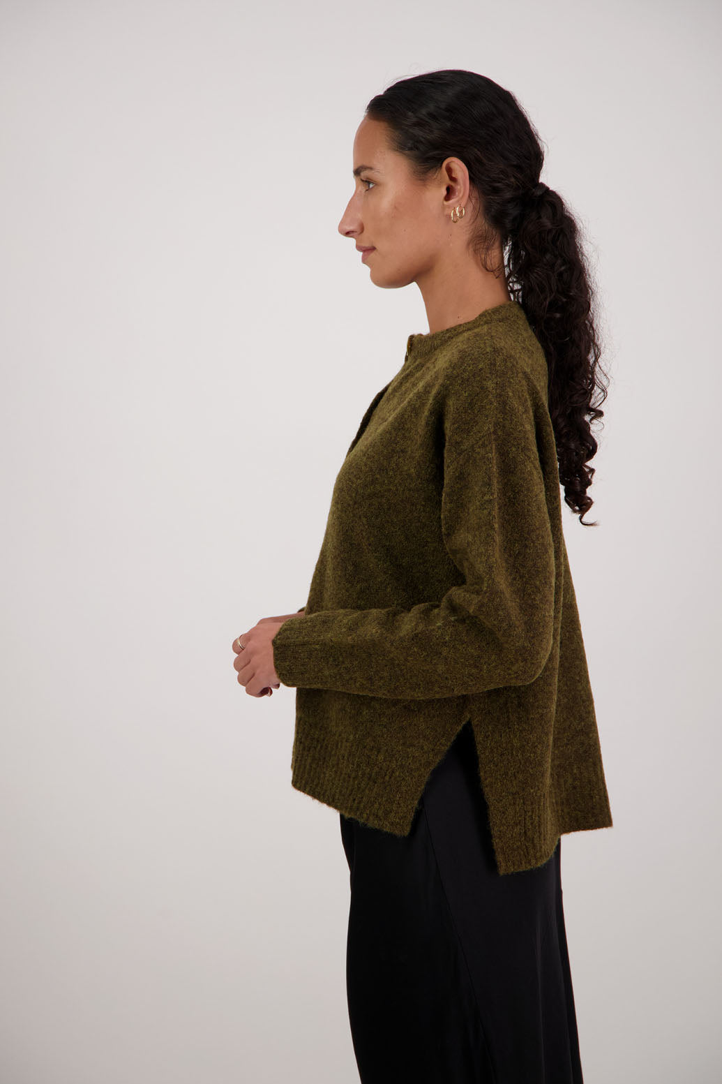 Fable Cardigan in Olive by Briarwood NZ. Alpaca/Wool blend long sleeve cardigan with side splits and longer at the back