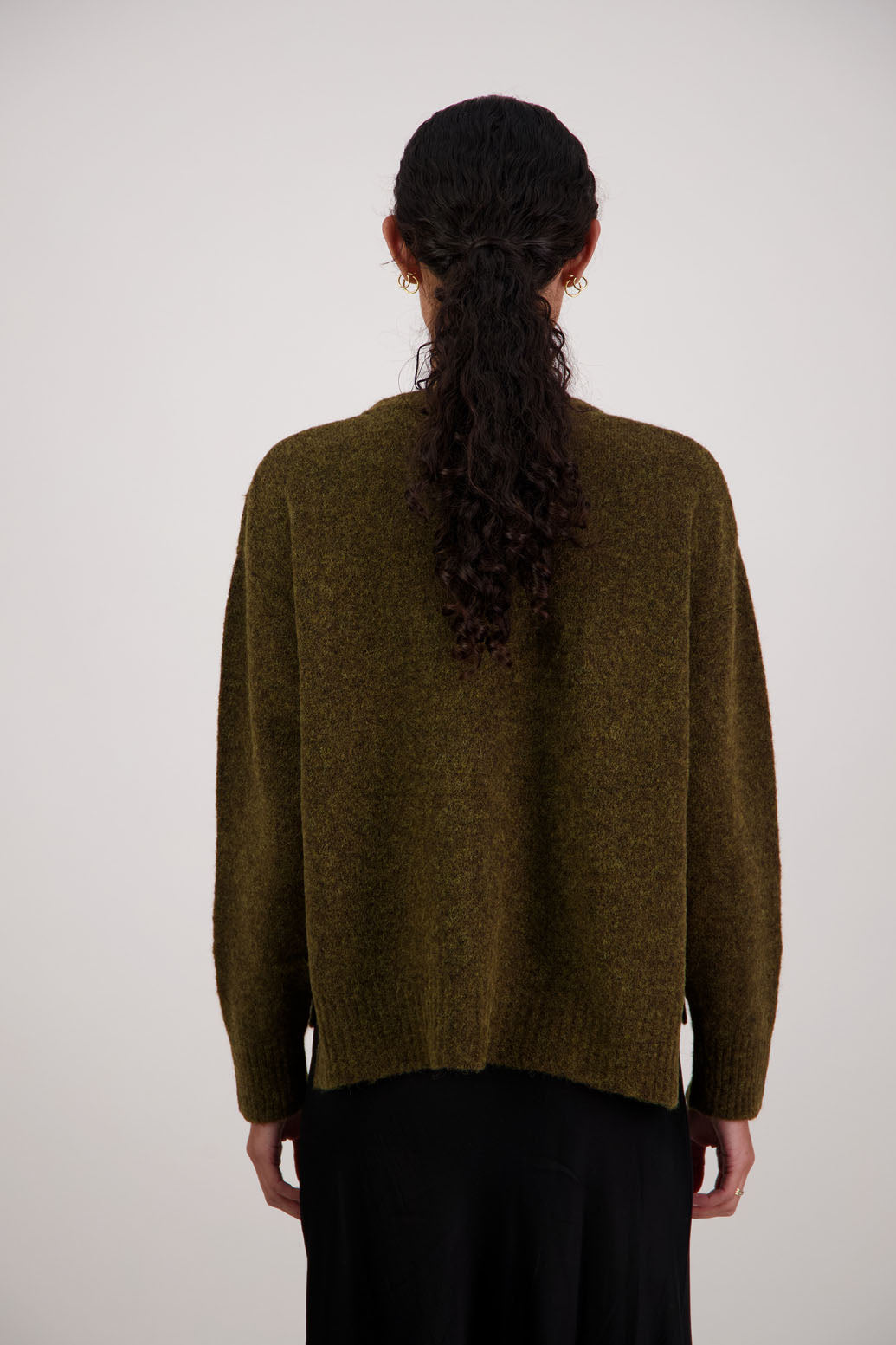 Fable Cardigan in Olive by Briarwood NZ. Alpaca/Wool blend long sleeve cardigan with side splits and longer at the back