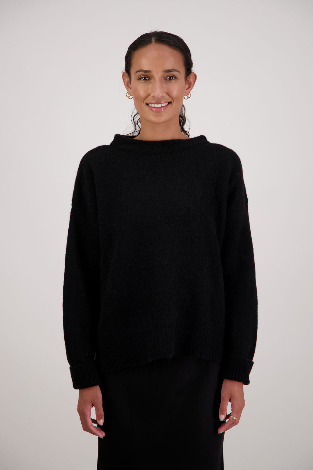 Feather Jumper in Black by Briarwood NZ. Alpaca/Wool blend long sleeve, funnel neck jumper with side splits and longer at the back