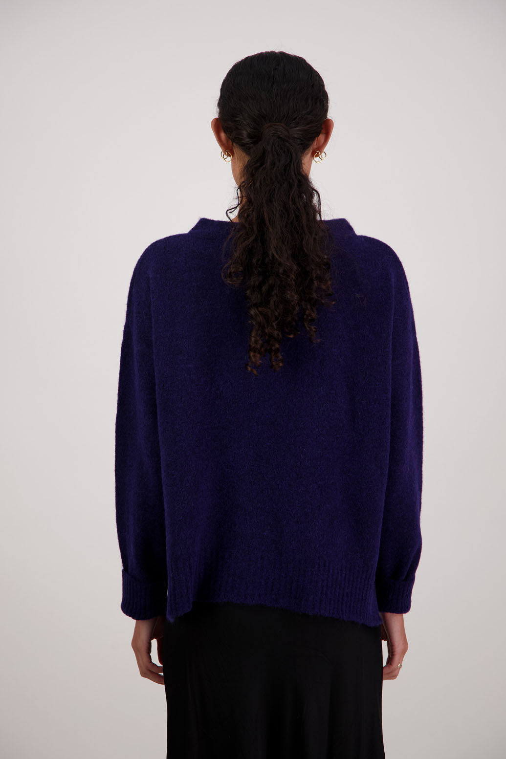 Feather Jumper in Ink by Briarwood NZ. Alpaca/Wool blend long sleeve, funnel neck jumper with side splits and longer at the back