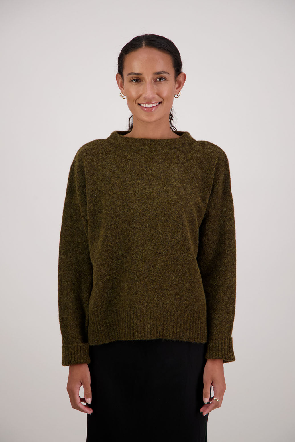 Feather Jumper in Olive by Briarwood NZ. Alpaca/Wool blend long sleeve, funnel neck jumper with side splits and longer at the back
