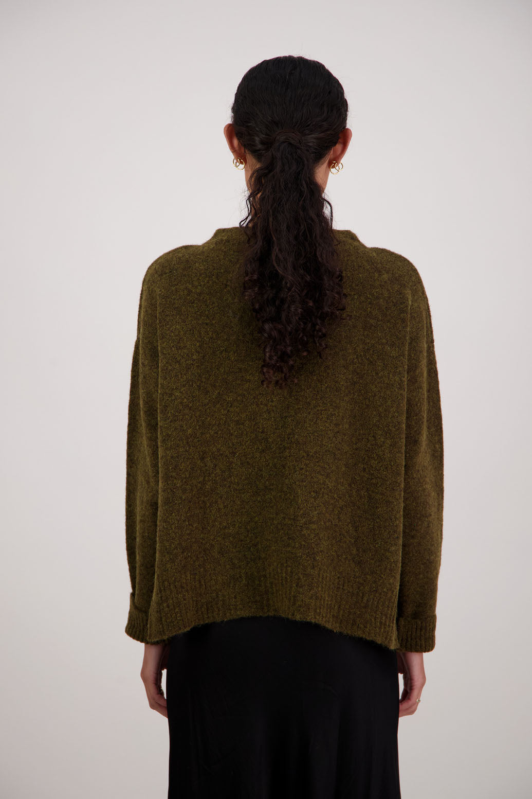 Feather Jumper in Olive by Briarwood NZ. Alpaca/Wool blend long sleeve, funnel neck jumper with side splits and longer at the back