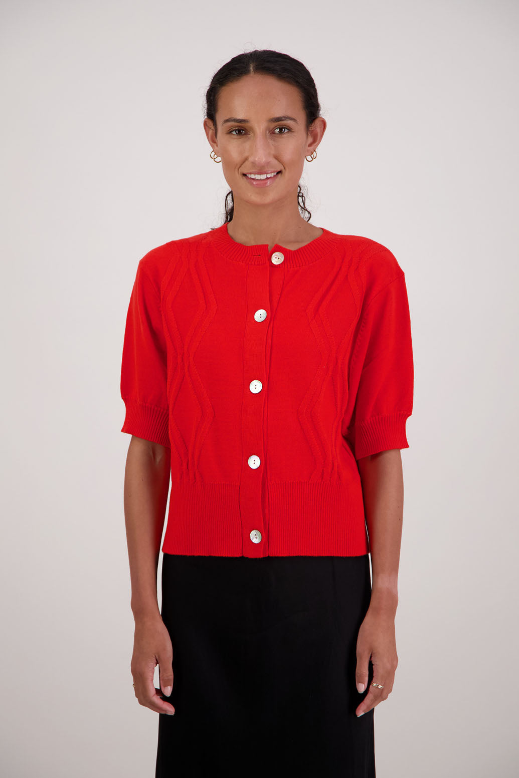 French Wool Cardigan in Orange by Briarwood NZ. 100% Wool cardigan with short sleeves, buttoned front, wide waist band and self pattern on front