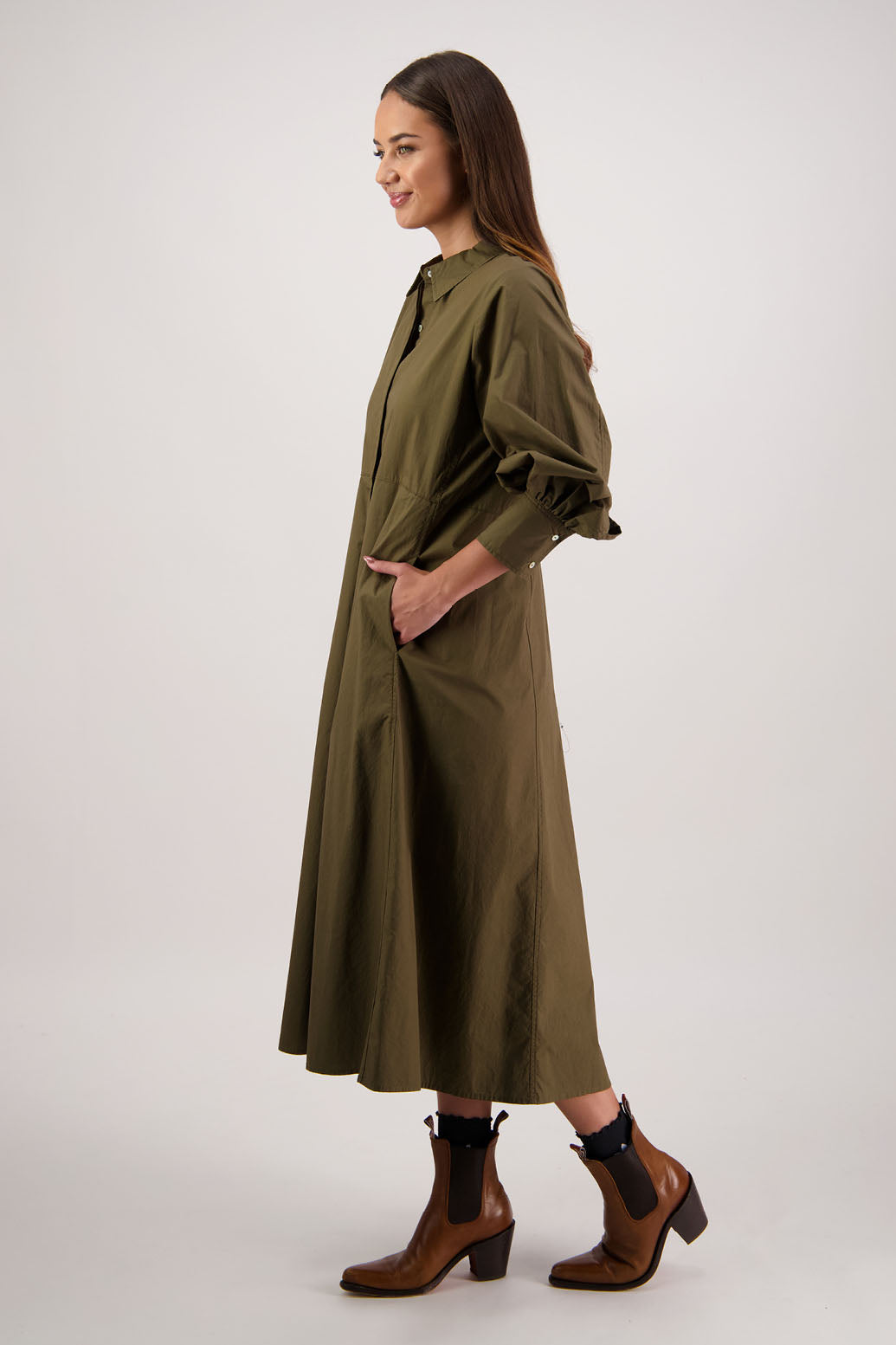 Henrietta Shirt Dress in Khaki by Briarwood NZ. Made from Cotton Poplin with long full length sleeves, fitted through the body, fitted through the maxi with maxi a-line skirt, hidden button front and extended cuff with 2 buttons