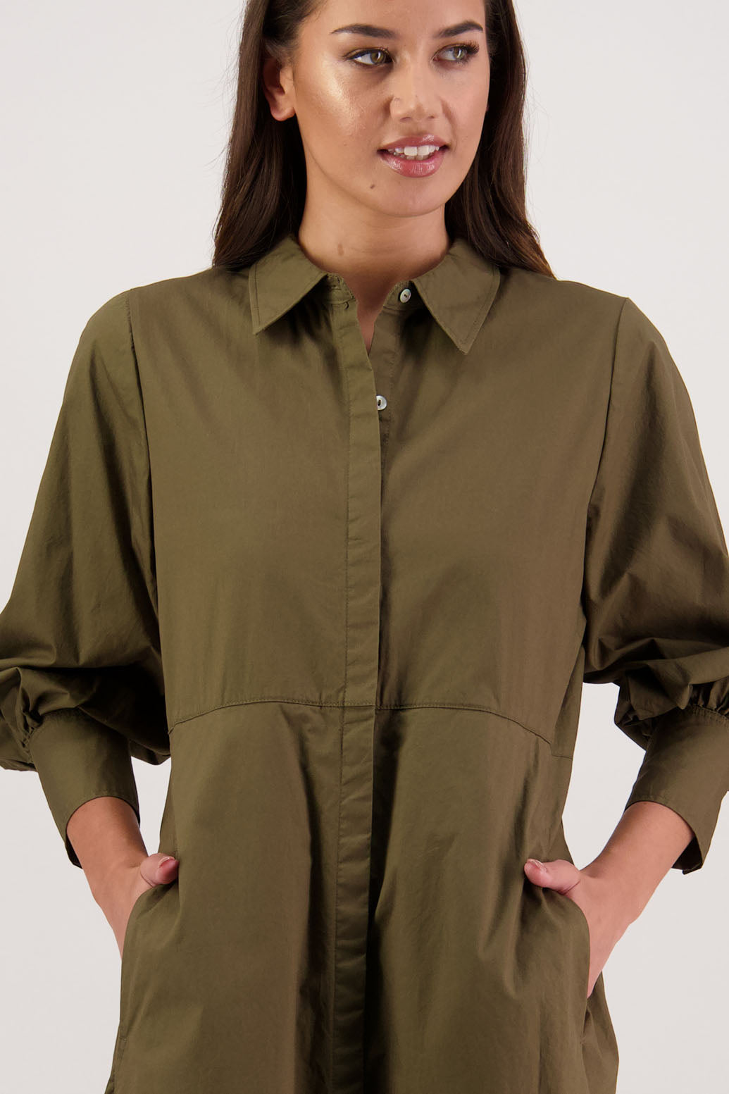 Henrietta Shirt Dress in Khaki by Briarwood NZ. Made from Cotton Poplin with long full length sleeves, fitted through the body, fitted through the maxi with maxi a-line skirt, hidden button front and extended cuff with 2 buttons