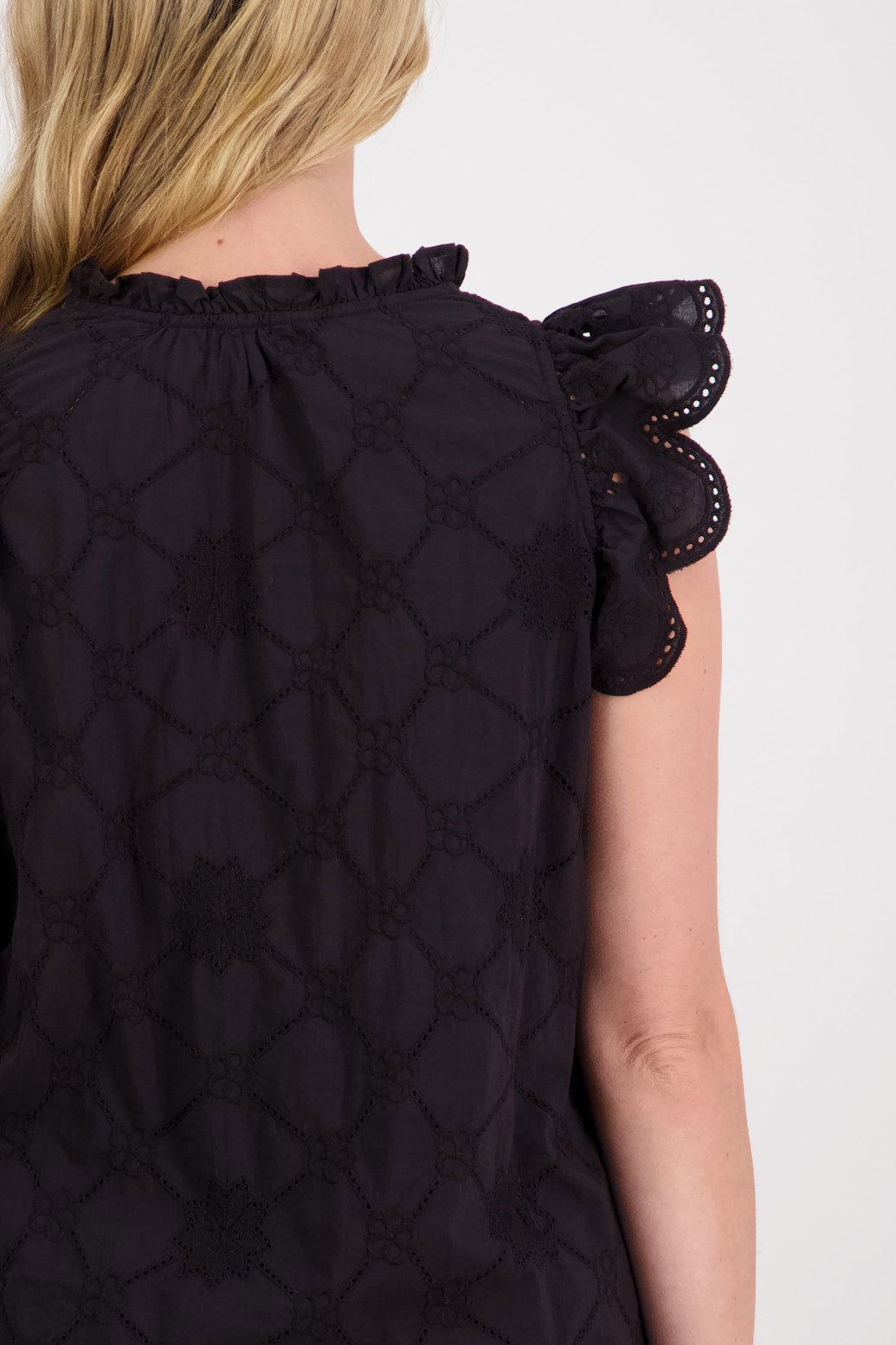 Page Womens Black Embroidery Anglaise Top With Ruffle Sleeves. Slight ruffle around the neck and slightly longer at the back.