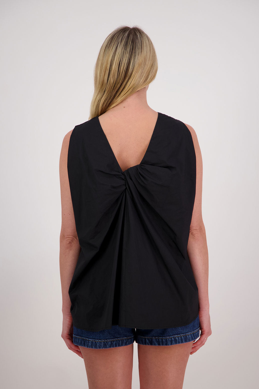 Patsy sleeveless wide shoulder twist back top in Cotton, Black