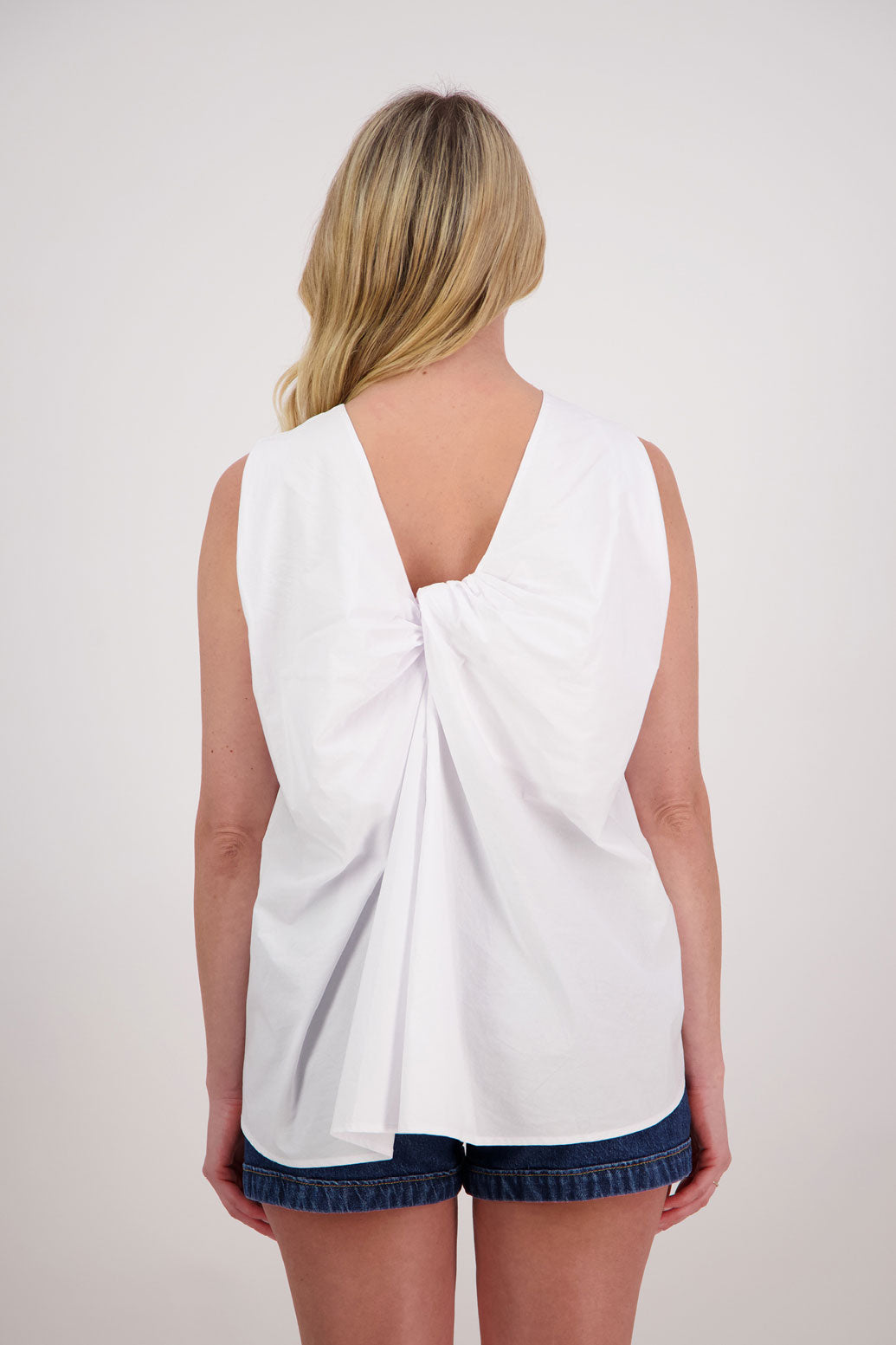 Patsy sleeveless wide shoulder twist back top in Cotton, White