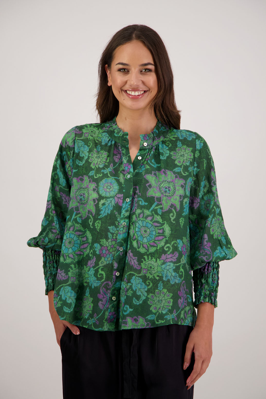 Raewyn Shirt in Green Floral by Briarwood NZ. 100% Ramie shirt with long sleeves, ruffle neckline, shirred waist and button front.