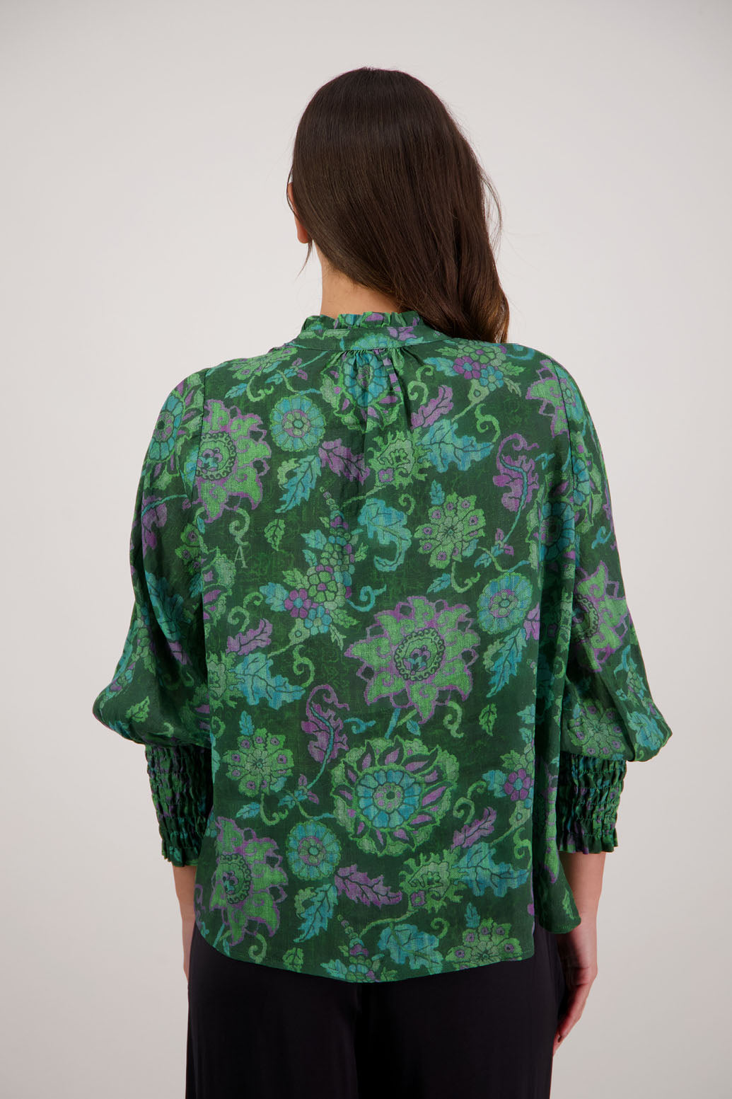 Raewyn Shirt in Green Floral by Briarwood NZ. 100% Ramie shirt with long sleeves, ruffle neckline, shirred waist and button front.