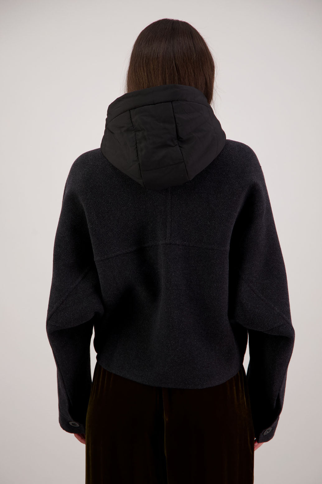 Raine Jacket in Black by Briarwood NZ. Features, wool/cashmere/polyester body, short and wide, bat wing type sleeve, nylon hood with magnetic closure, pockets, buttons down the front