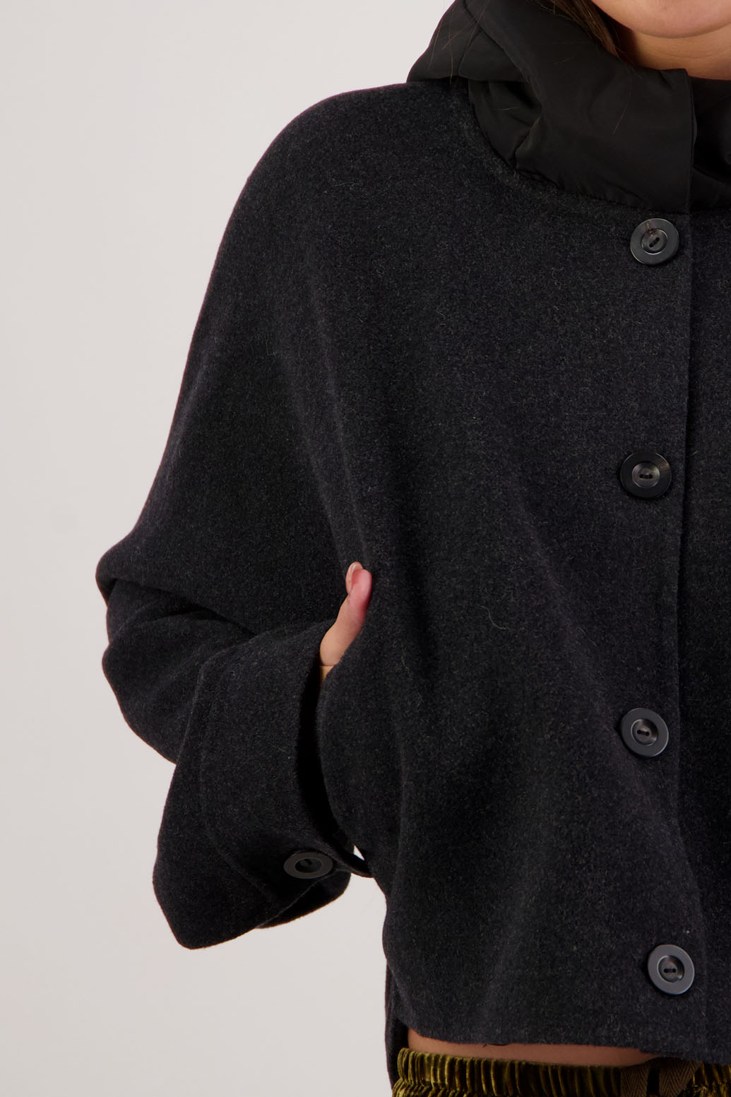 Raine Jacket in Black by Briarwood NZ. Features, wool/cashmere/polyester body, short and wide, bat wing type sleeve, nylon hood with magnetic closure, pockets, buttons down the front