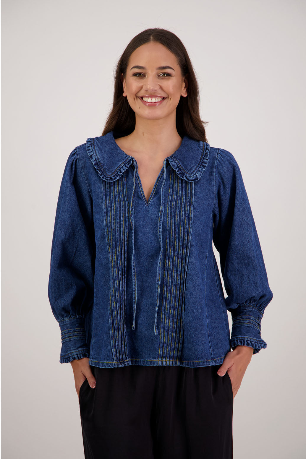 Redmond Denim Top by Briarwood NZ. 100% cotton top with pin tucks, shaped collar with ruffle and tie, full length sleeves with pin tucks on buttoned cuff