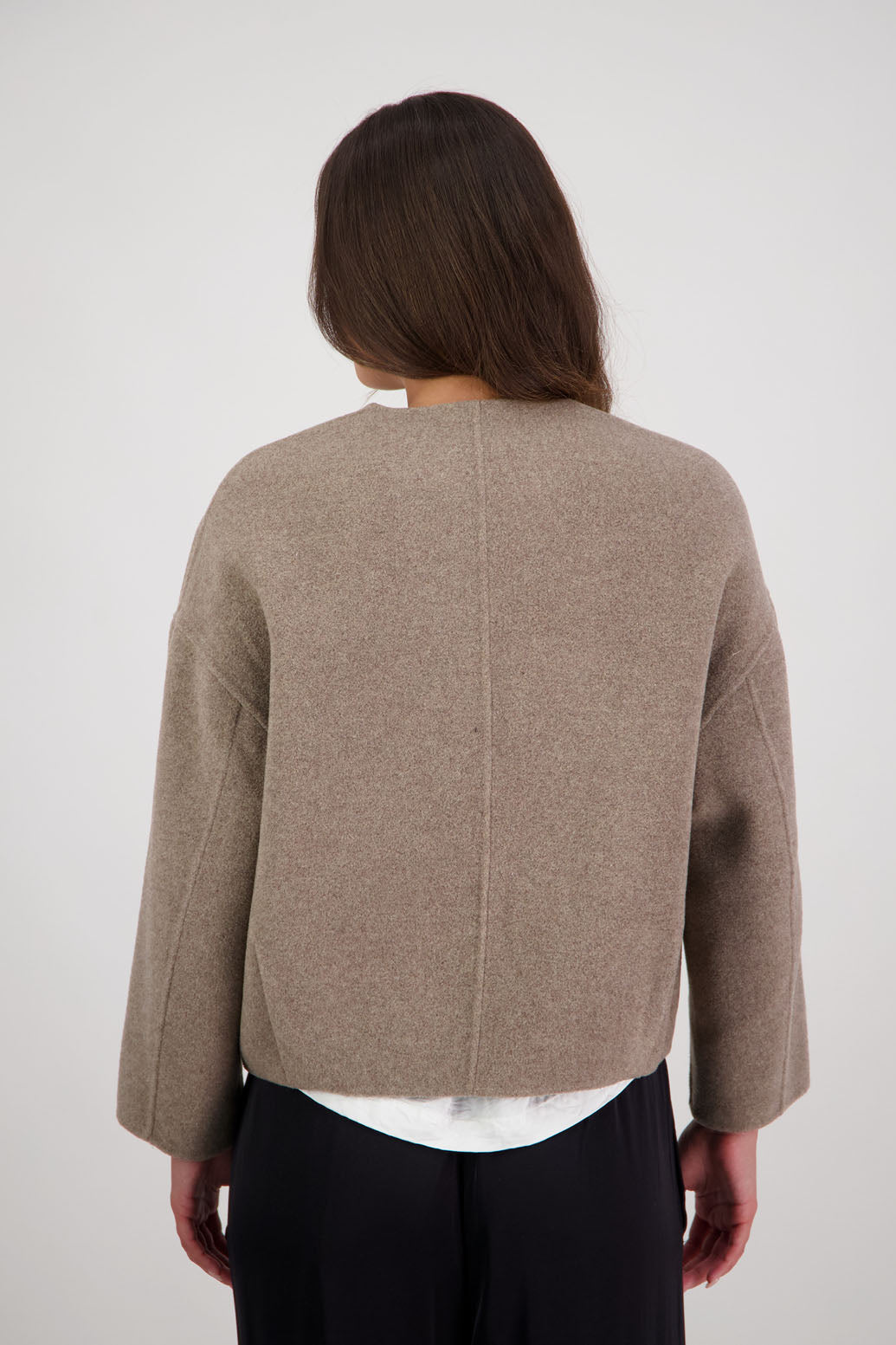 Renee Jacket in Taupe by Briarwood NZ. Features, no collar, button closure, shaped sleeves, pockets, drop shoulder and dart type pleats on the hem of the jacket