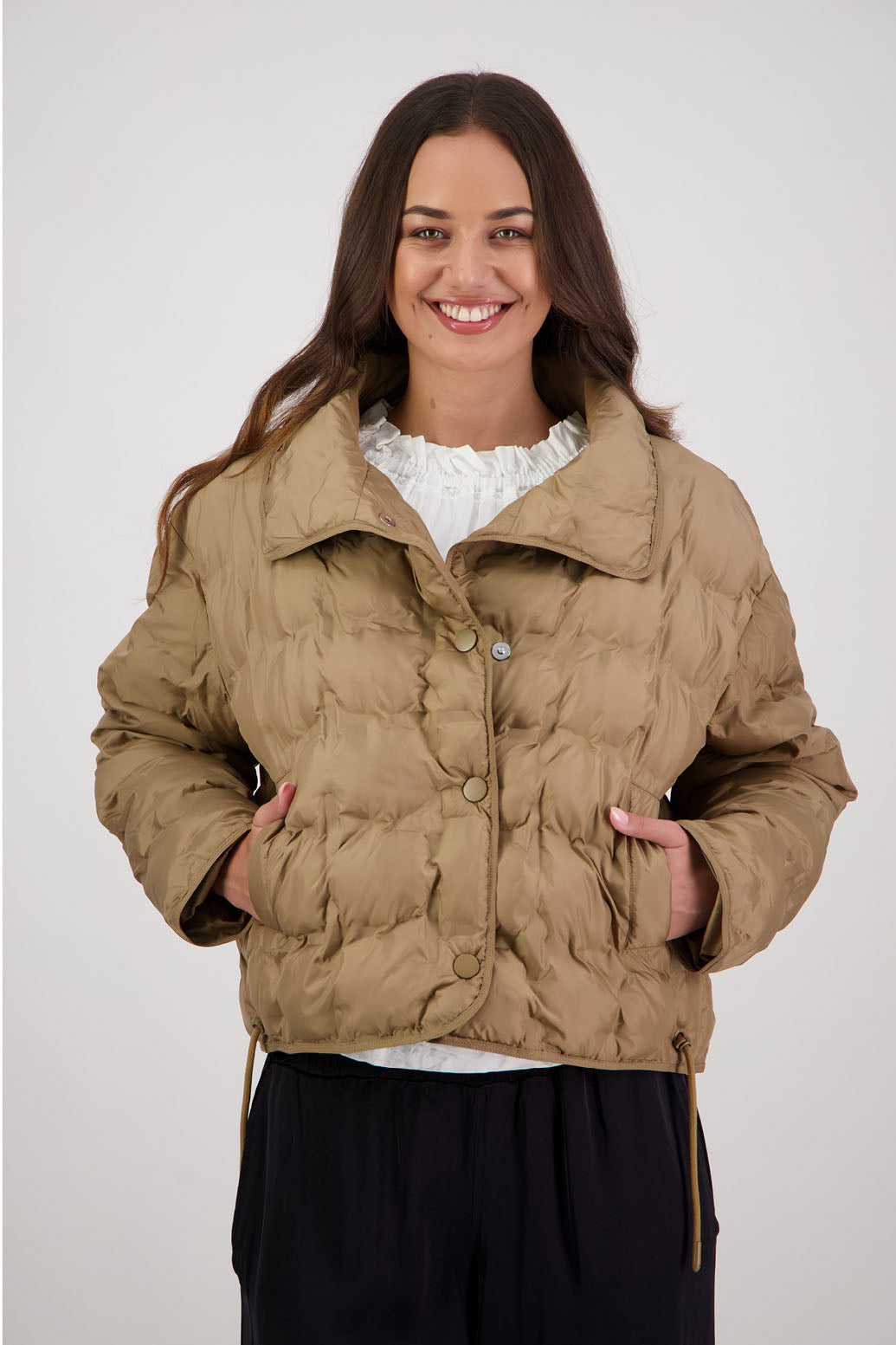 Rhodes Padded Jacket in Tan by Briarwood NZ. Features, magnetic dome closures, filled with plush fibres, elastic pull across the back with toggles to hold it in place, high collar with invisible magnetic closure, pockets