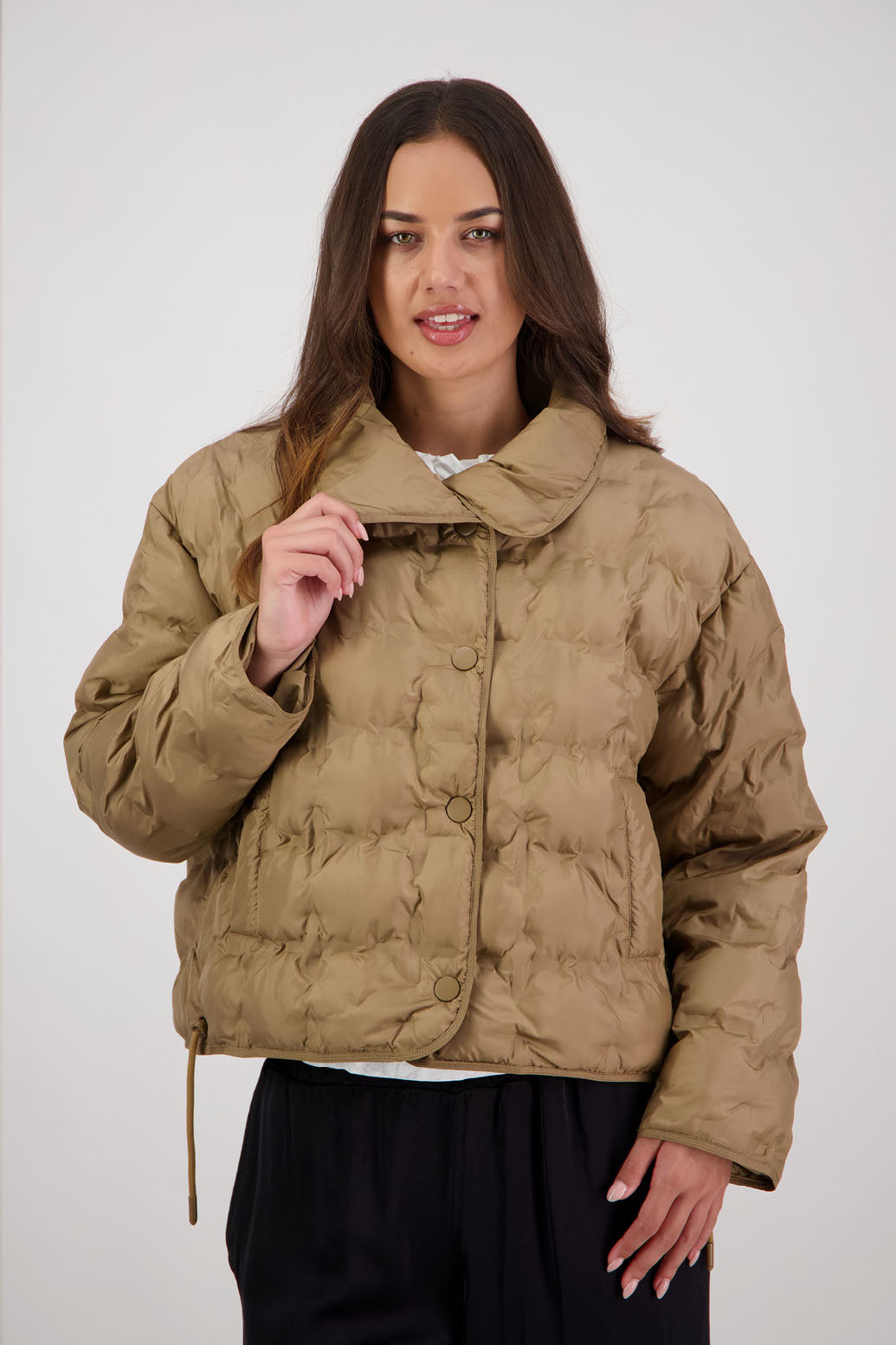 Rhodes Padded Jacket in Tan by Briarwood NZ. Features, magnetic dome closures, filled with plush fibres, elastic pull across the back with toggles to hold it in place, high collar with invisible magnetic closure, pockets