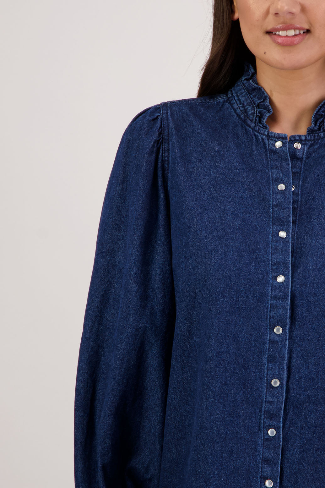 Ricci Denim Shirt by Briarwood NZ. 100% cotton shirt with full length sleeves, snap button closure, ruffles around neck