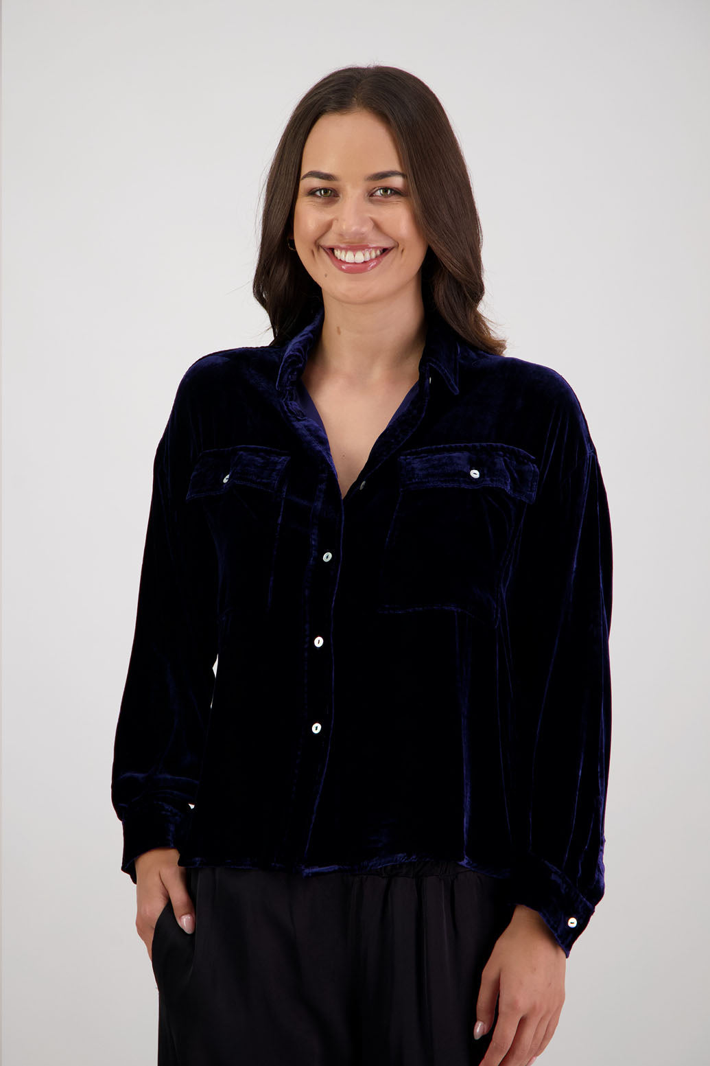 Ridge Shirt in Ink Velvet by Briarwood NZ. A
18% Silk, 82% Rayon Velvet collared button through shirt with full length sleeves, longer at the back, side splits, pockets on front