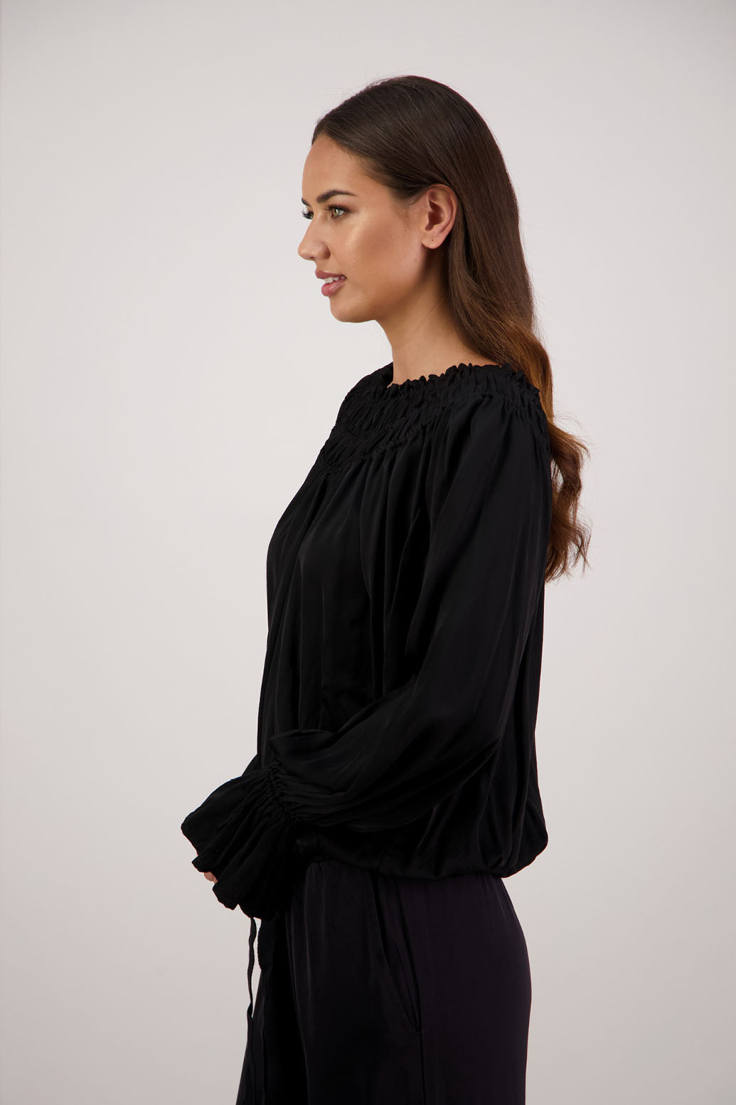 Rosemarie Top in Black by Briarwood NZ. 100% viscose top with 3 panel gathered neck, full length sleeves with ruffle, elasticated waistband