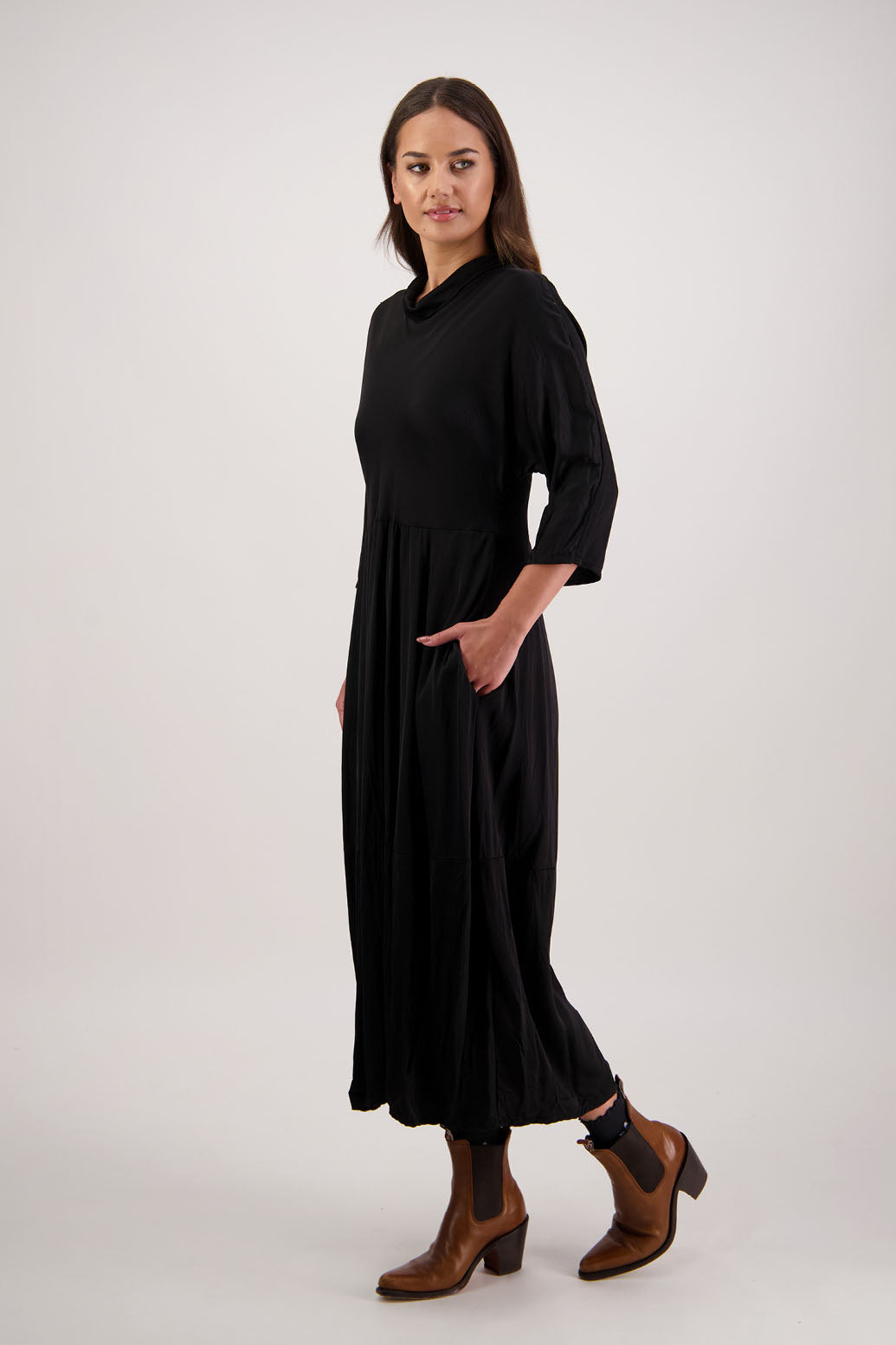 Rowena Dress in Black by Briarwood NZ. 100% viscose dress, roll neck, bias cut top, puff hem start, 3/4 sleeves, pockets, lined