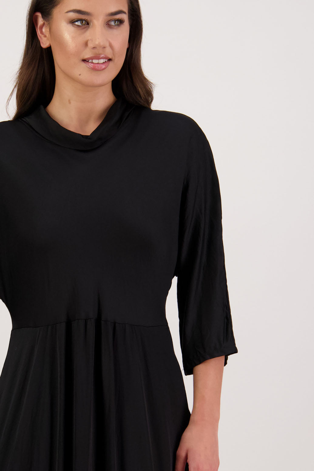 Rowena Dress in Black by Briarwood NZ. 100% viscose dress, roll neck, bias cut top, puff hem start, 3/4 sleeves, pockets, lined
