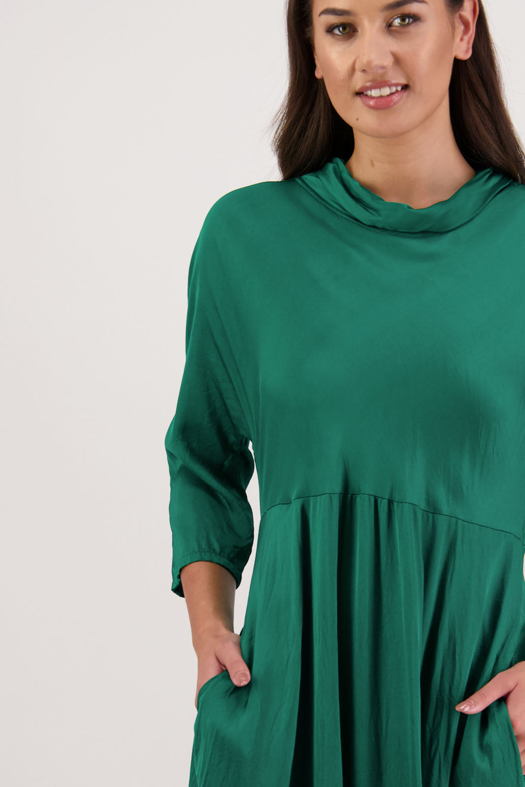Rowena Dress in Emerald by Briarwood NZ. 100% viscose dress, roll neck, bias cut top, puff hem start, 3/4 sleeves, pockets, lined