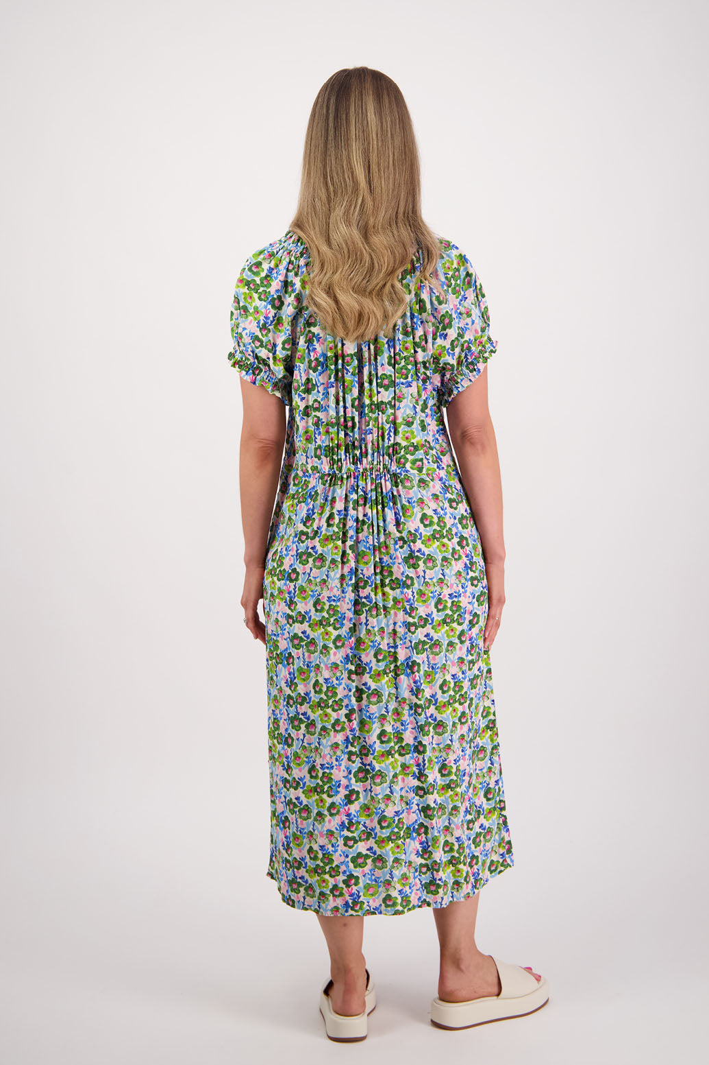 Womens long daisy print dress with slightly gathered centre panel, Ruffle around the neck and sleeves and pockets. Viscose. Briarwood NZ. Sasha