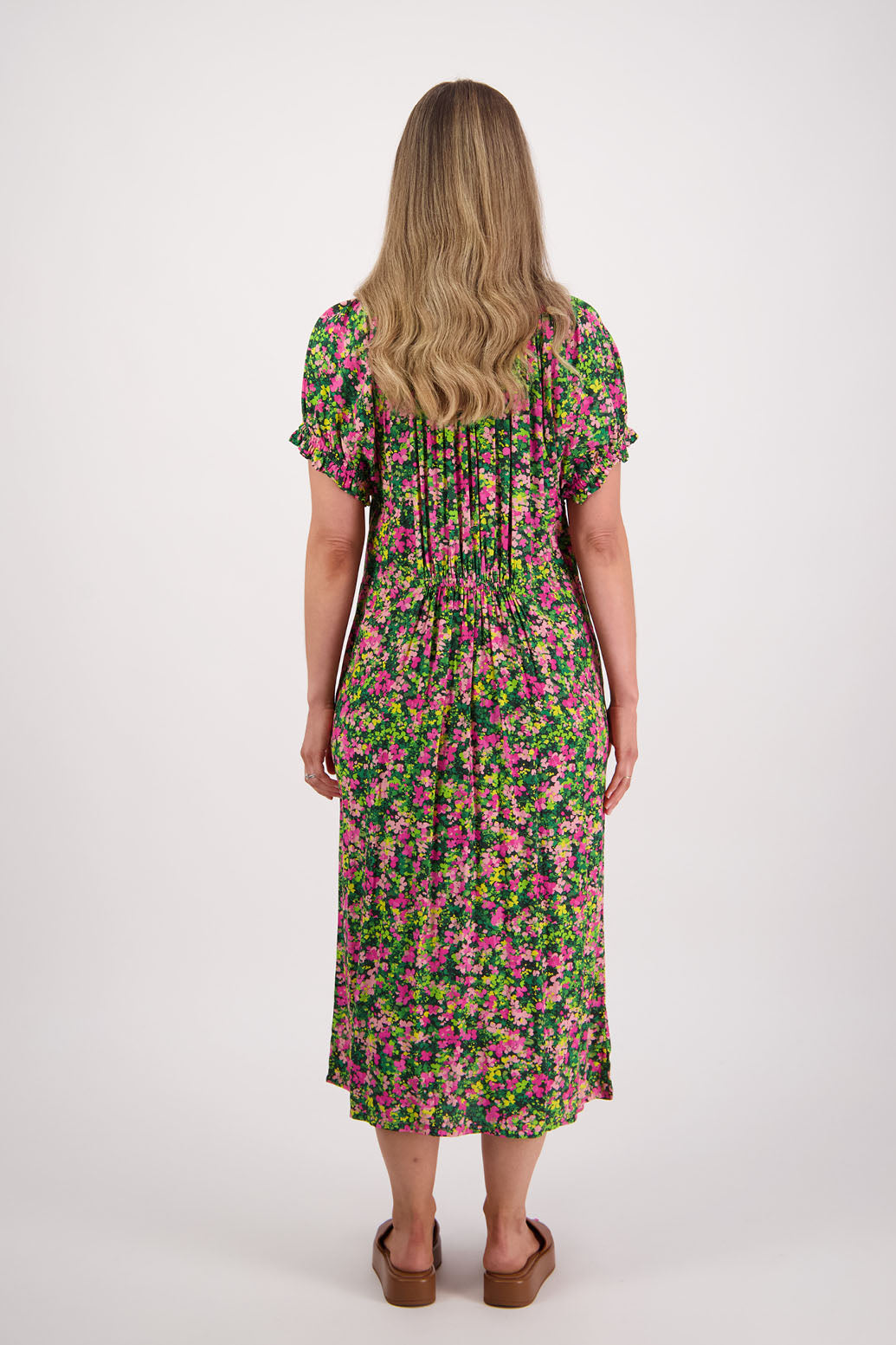 Womens long pansy print dress with slightly gathered centre panel, Ruffle around the neck and sleeves and pockets. Viscose. Briarwood NZ. Sasha