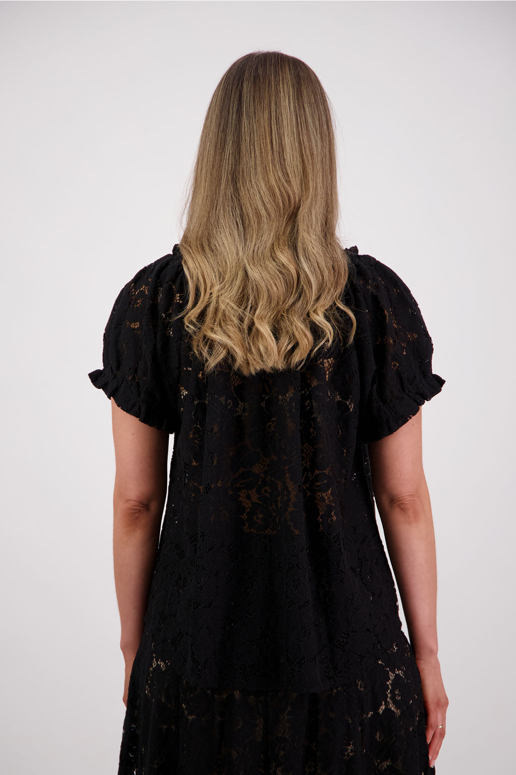 Womens black lace top with short sleeves elasticated neck and sleeves with slight ruffle. Briarwood NZ. Serenity Black