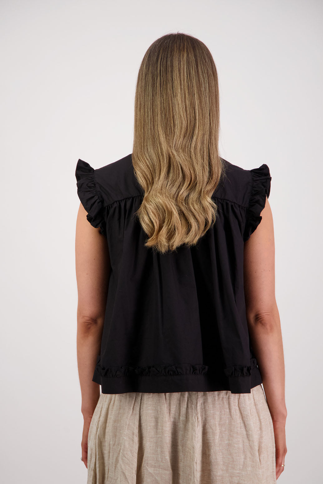 Womens black short sleeve wide top with V neck + tie, and small ruffle on the yolk, hem and sleeves. Briarwood NZ. Cotton Poplin. Skye