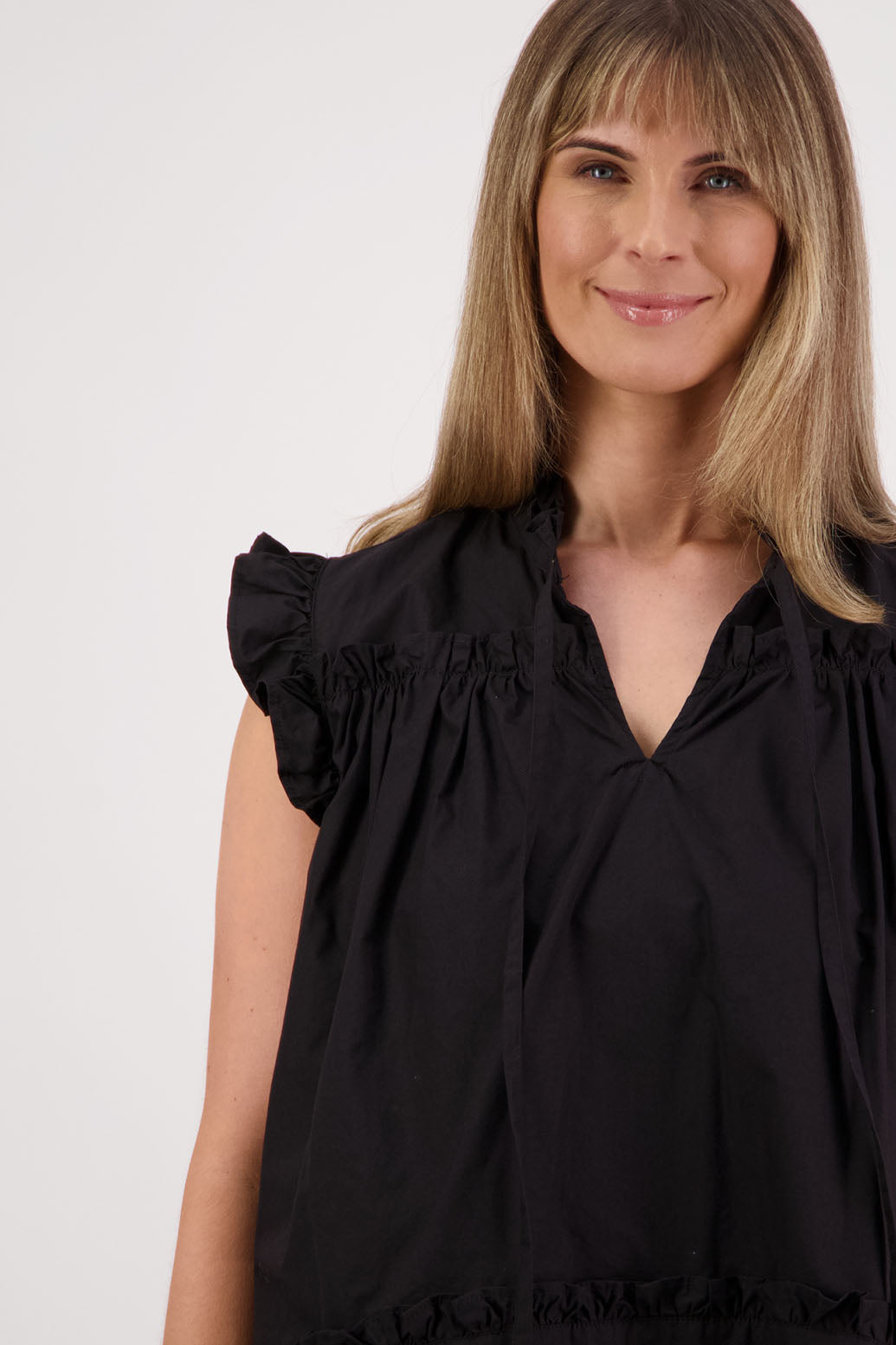 Womens black short sleeve wide top with V neck + tie, and small ruffle on the yolk, hem and sleeves. Briarwood NZ. Cotton Poplin. Skye