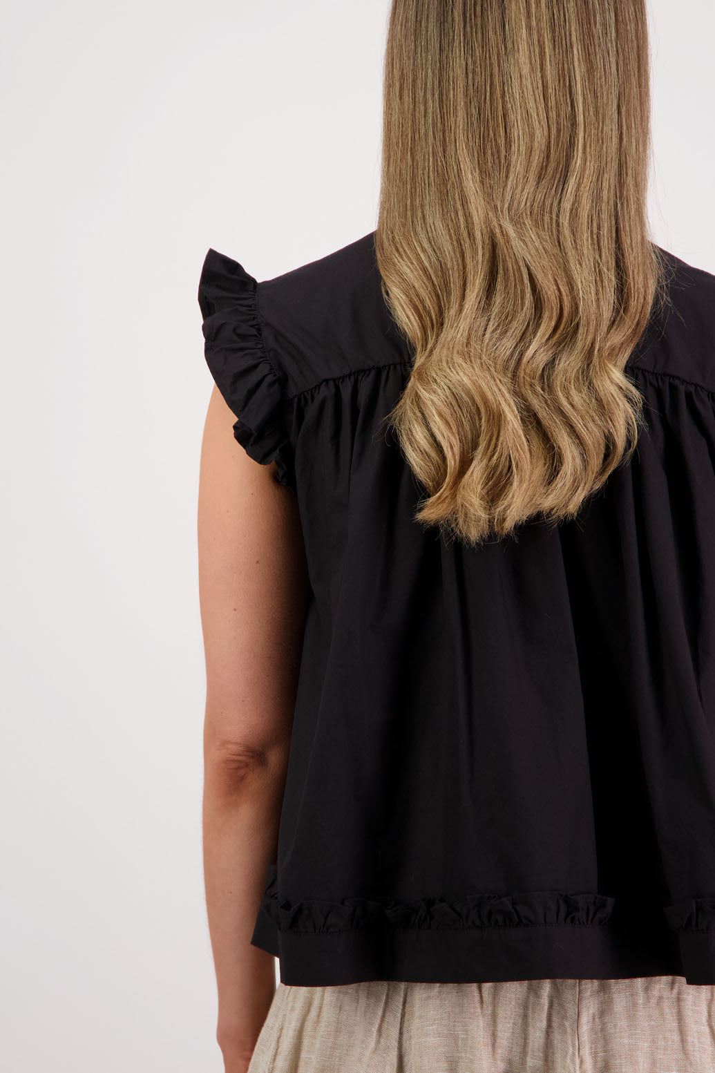 Womens black short sleeve wide top with V neck + tie, and small ruffle on the yolk, hem and sleeves. Briarwood NZ. Cotton Poplin. Skye