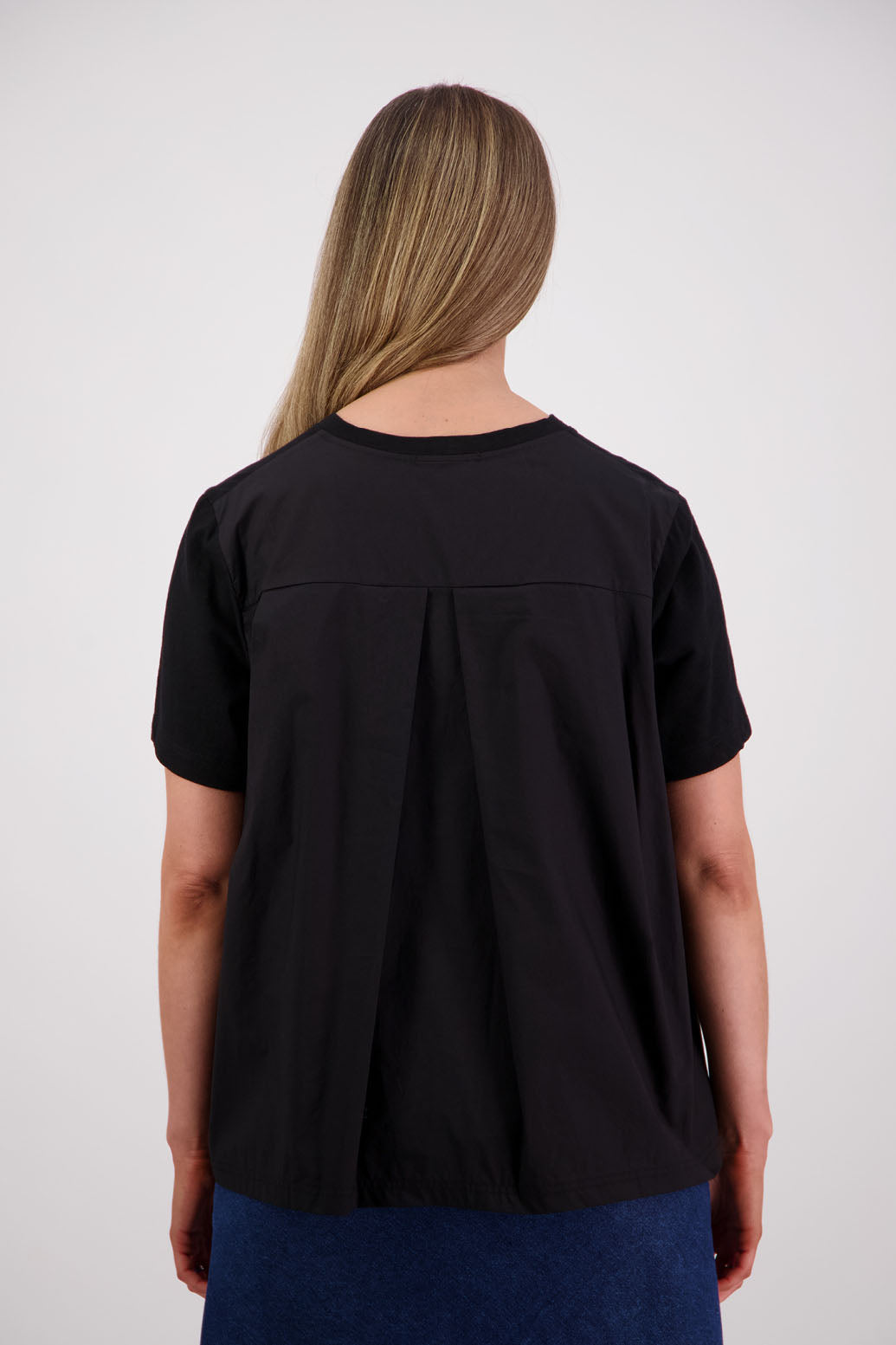 Womens oversized black cotton t-shirt with scooped neckline and swing back with cotton poplin pleat. Briarwood NZ. Smiley, Black