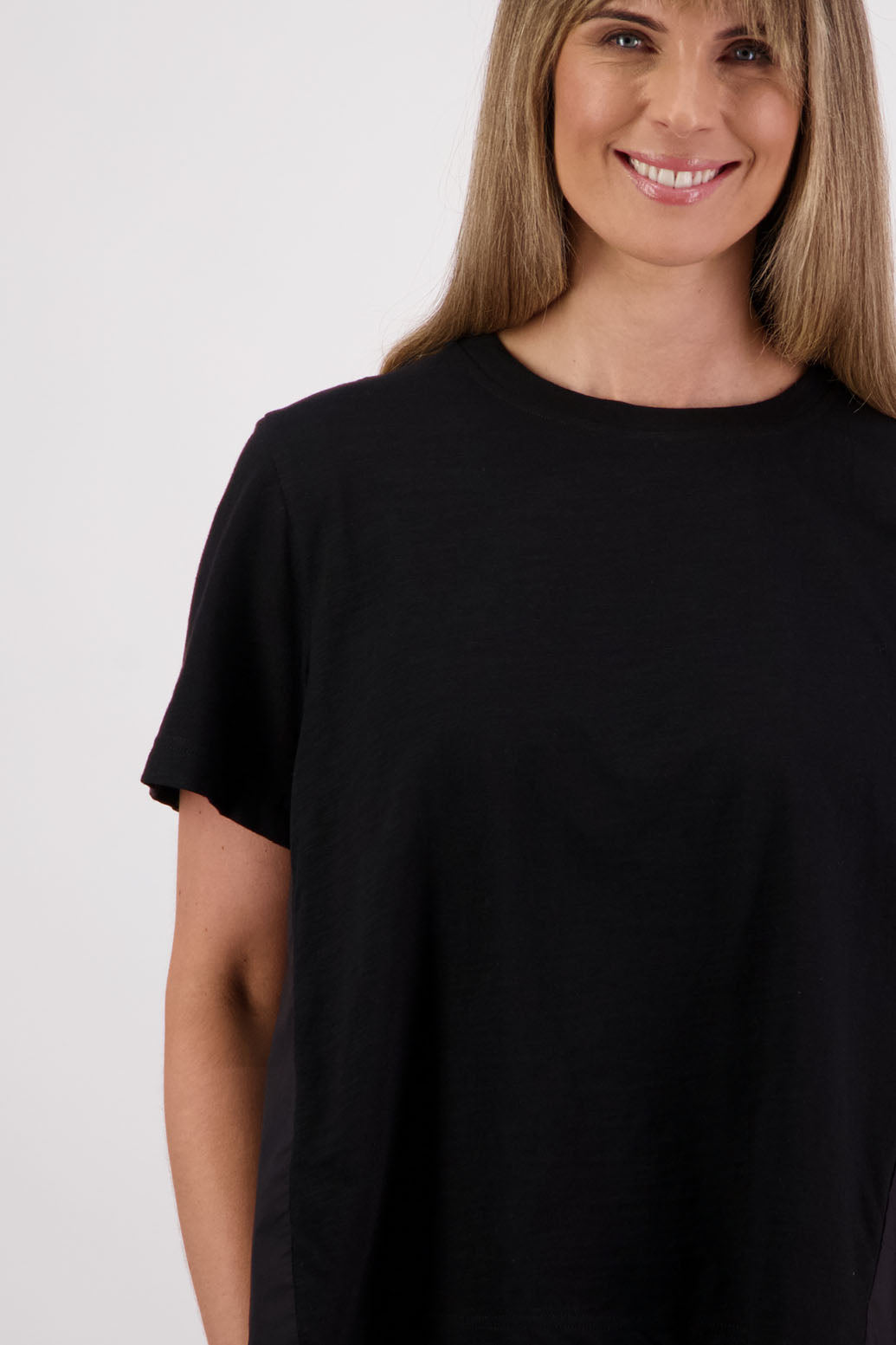 Womens oversized black cotton t-shirt with scooped neckline and swing back with cotton poplin pleat. Briarwood NZ. Smiley, Black