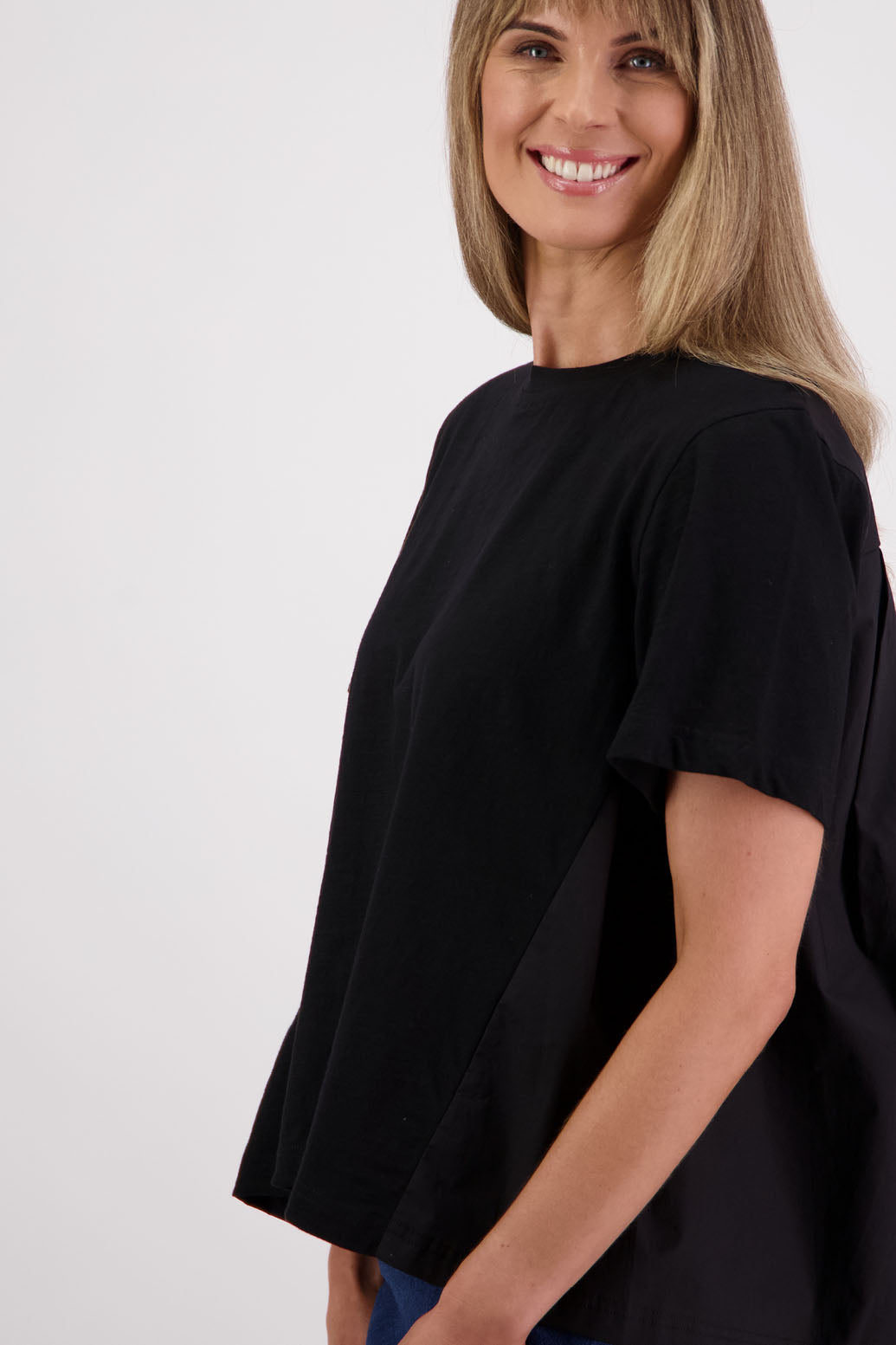 Womens oversized black cotton t-shirt with scooped neckline and swing back with cotton poplin pleat. Briarwood NZ. Smiley, Black