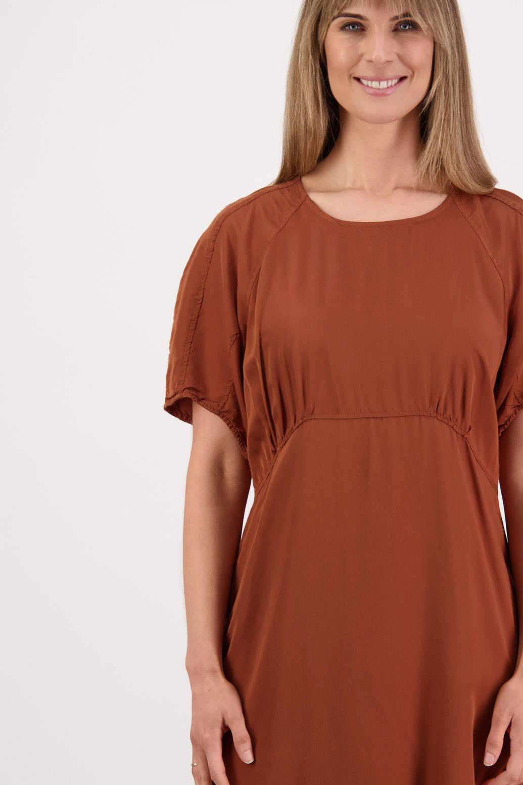 Womens tan dress with curved empire line bodice. Slim fitting body and midi length. Viscose. Briarwood NZ. Stacey