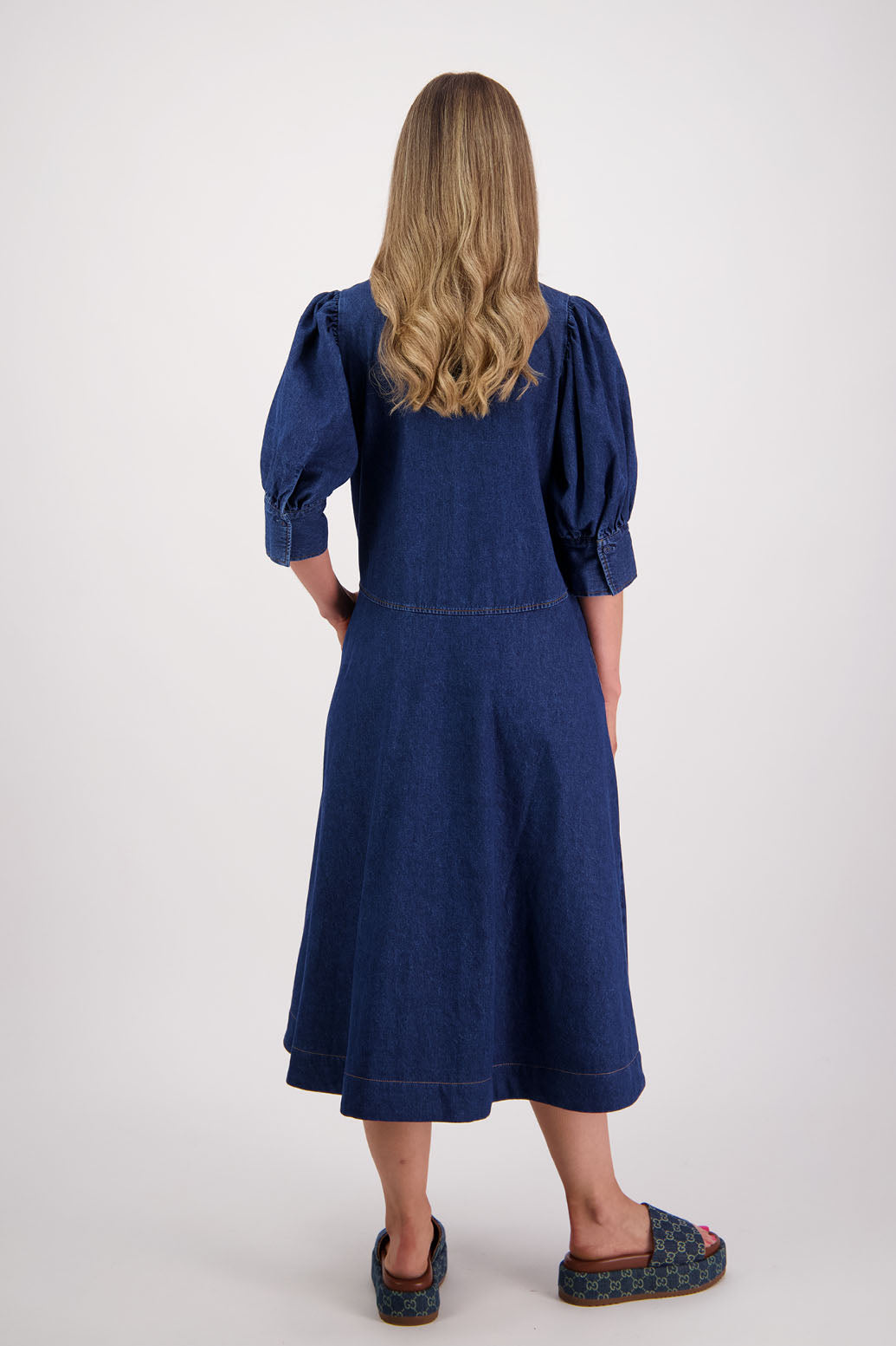 Womens denim dress with curved waist and slight puff below the elbow sleeves.Briarwood NZ. Steffie