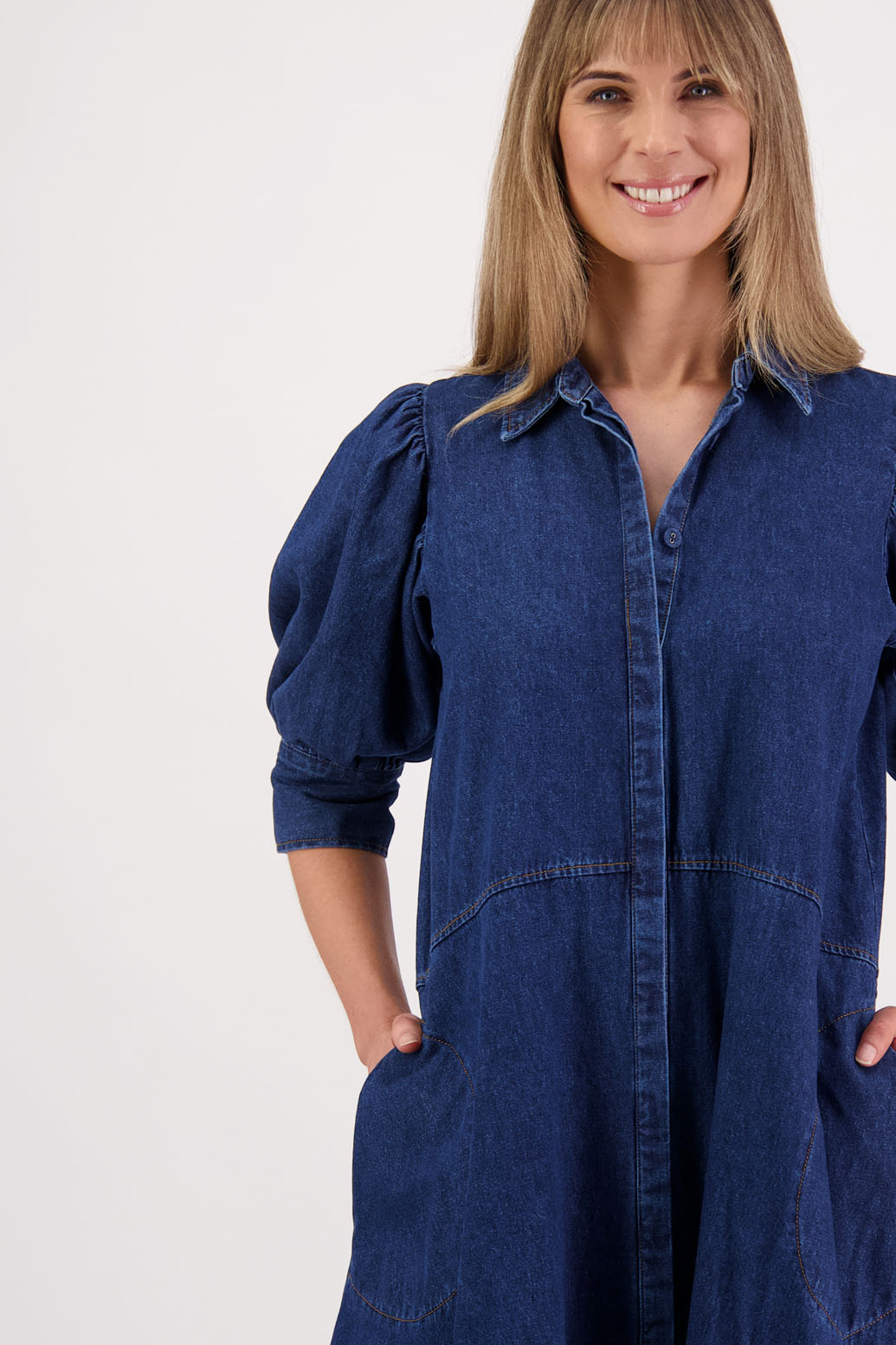 Womens denim dress with curved waist and slight puff below the elbow sleeves.Briarwood NZ. Steffie
