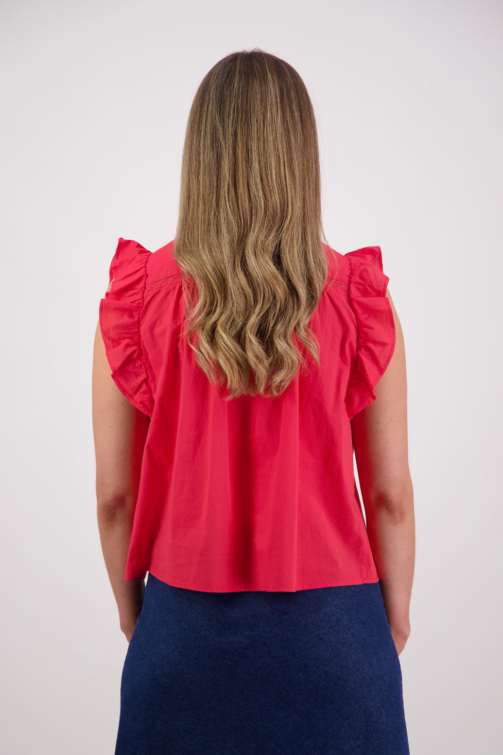 Womens red boho top with lace panels, pin tucks and signature ruffles over the shoulder. Briarwood NZ. Cotton Voile. Susan