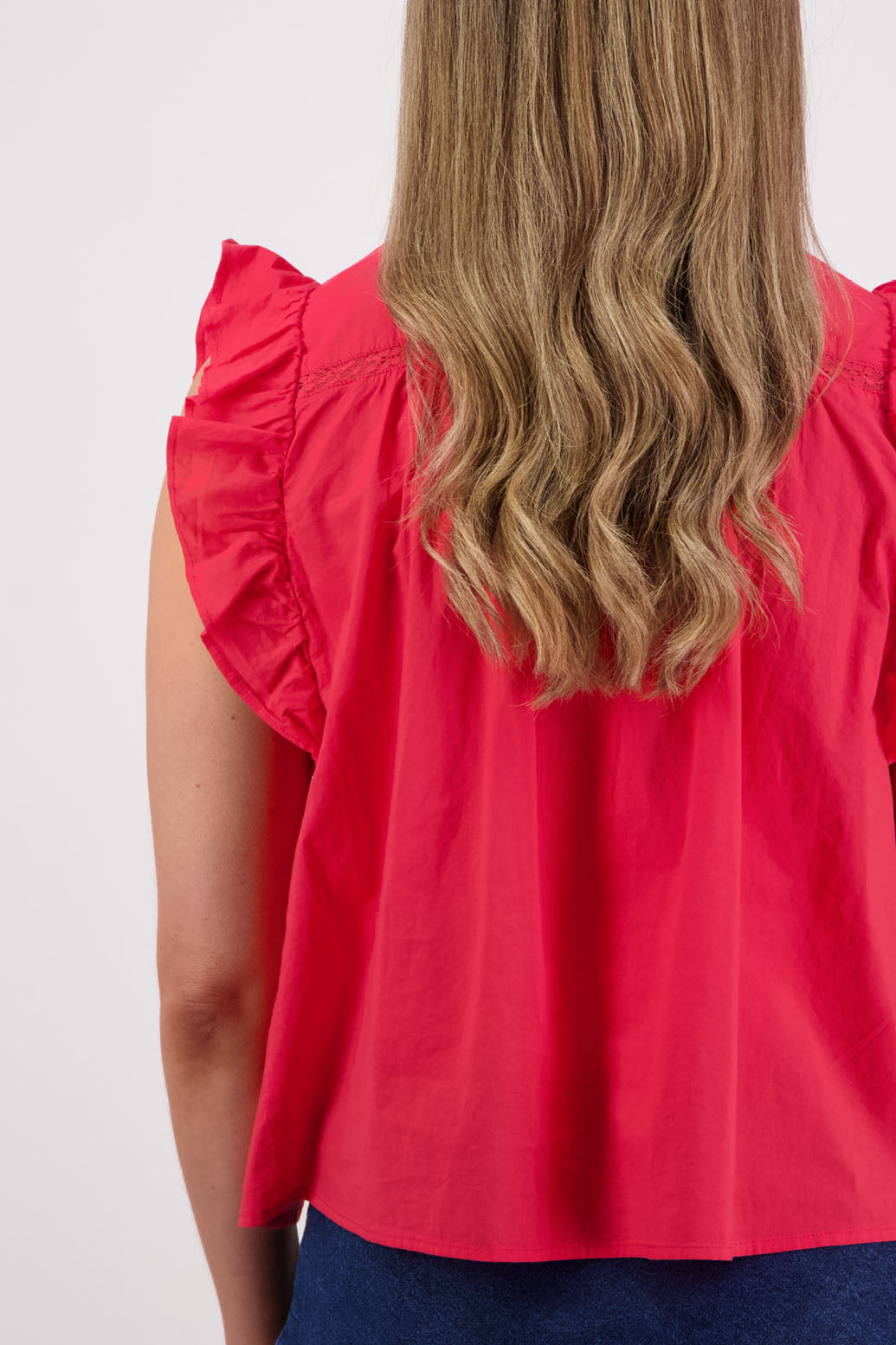 Womens red boho top with lace panels, pin tucks and signature ruffles over the shoulder. Briarwood NZ. Cotton Voile. Susan