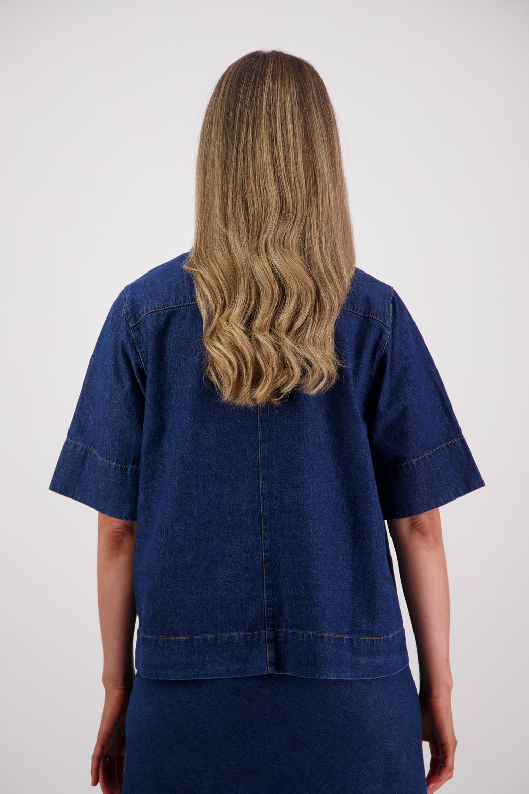 Womens box fit denim shirt with covered buttons, stitched on pockets and covered placket. Briarwood NZ. Syd