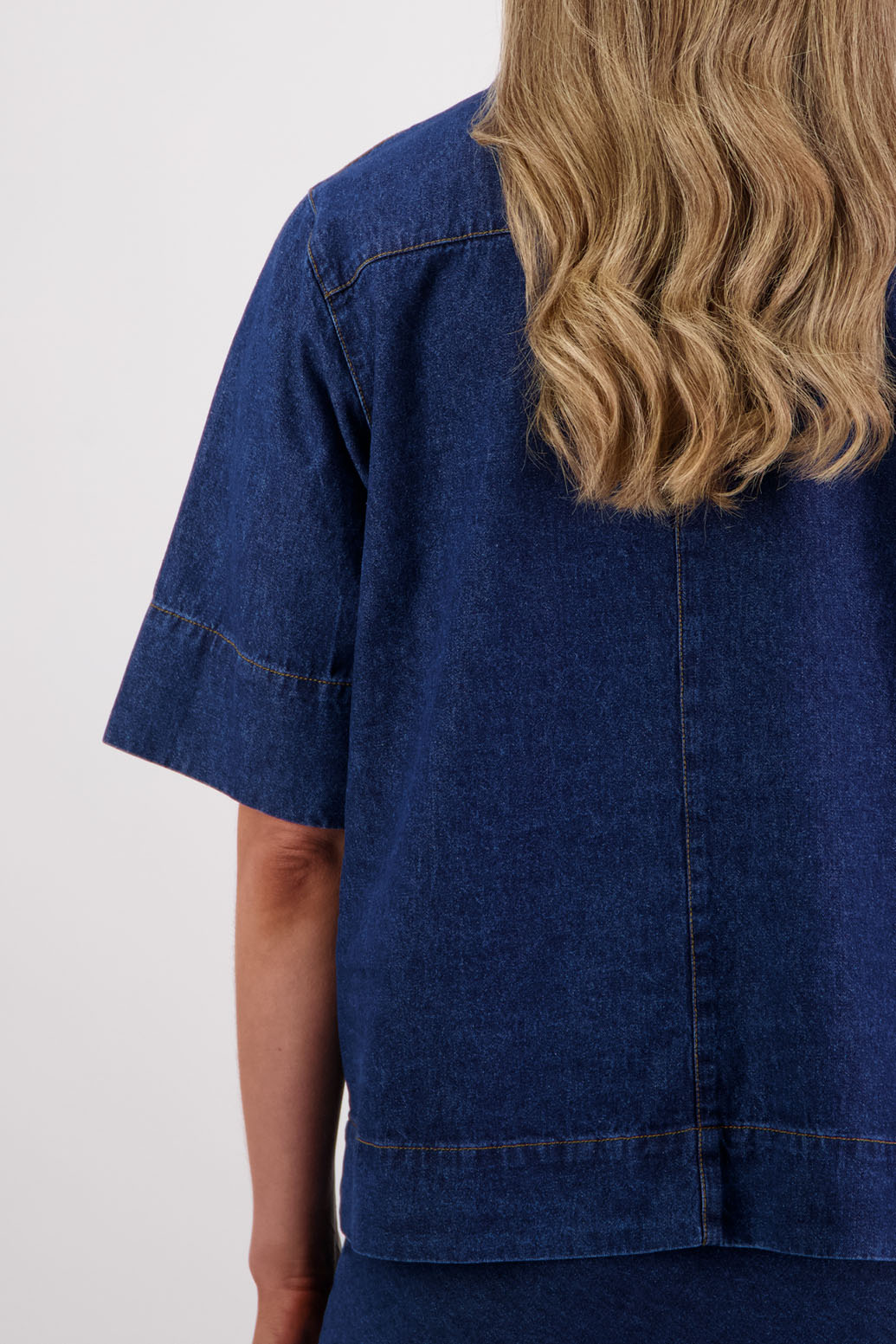Womens box fit denim shirt with covered buttons, stitched on pockets and covered placket. Briarwood NZ. Syd