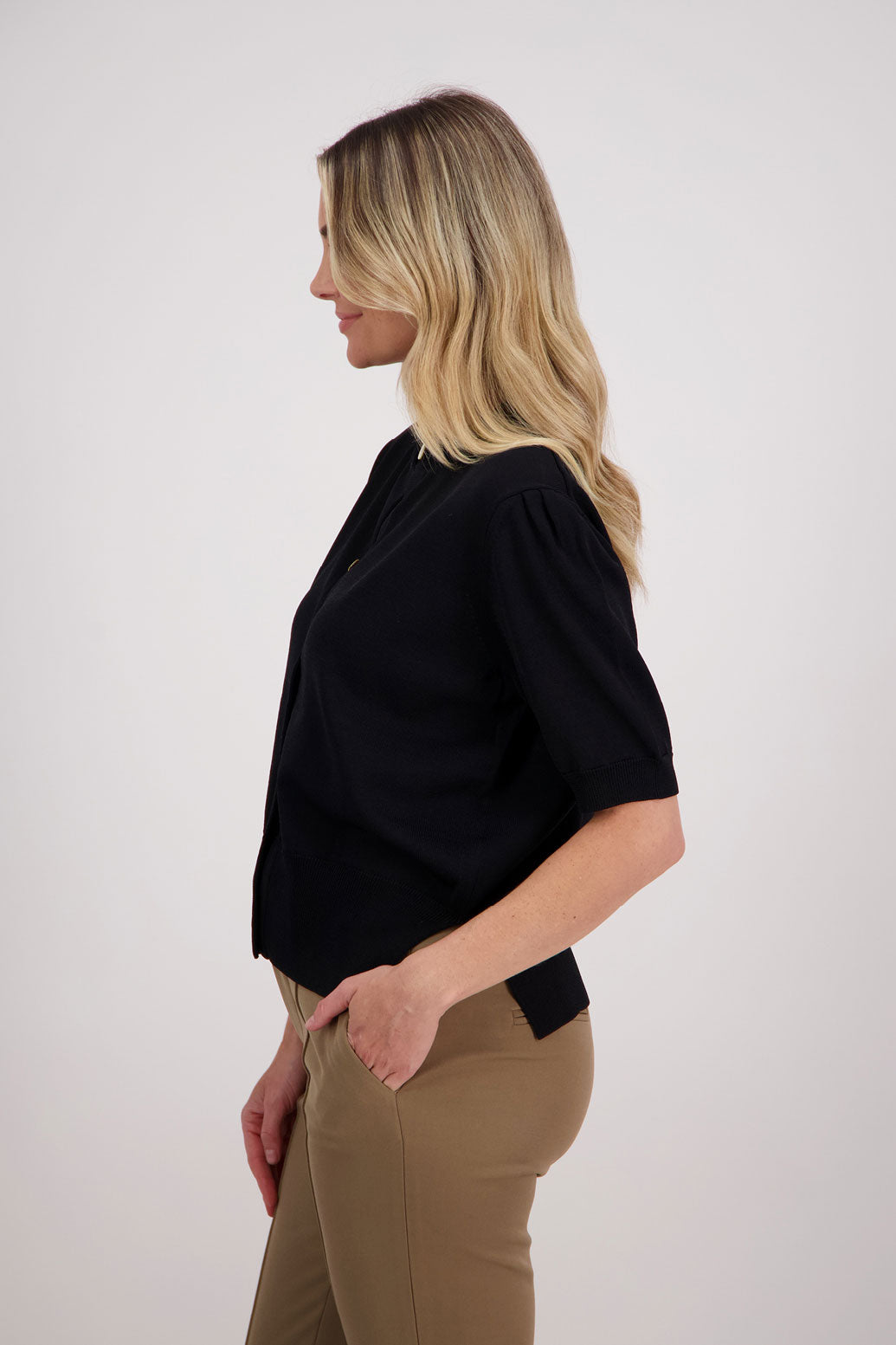 Classic black cardigan with elbow length sleeves, side split hem. Vera