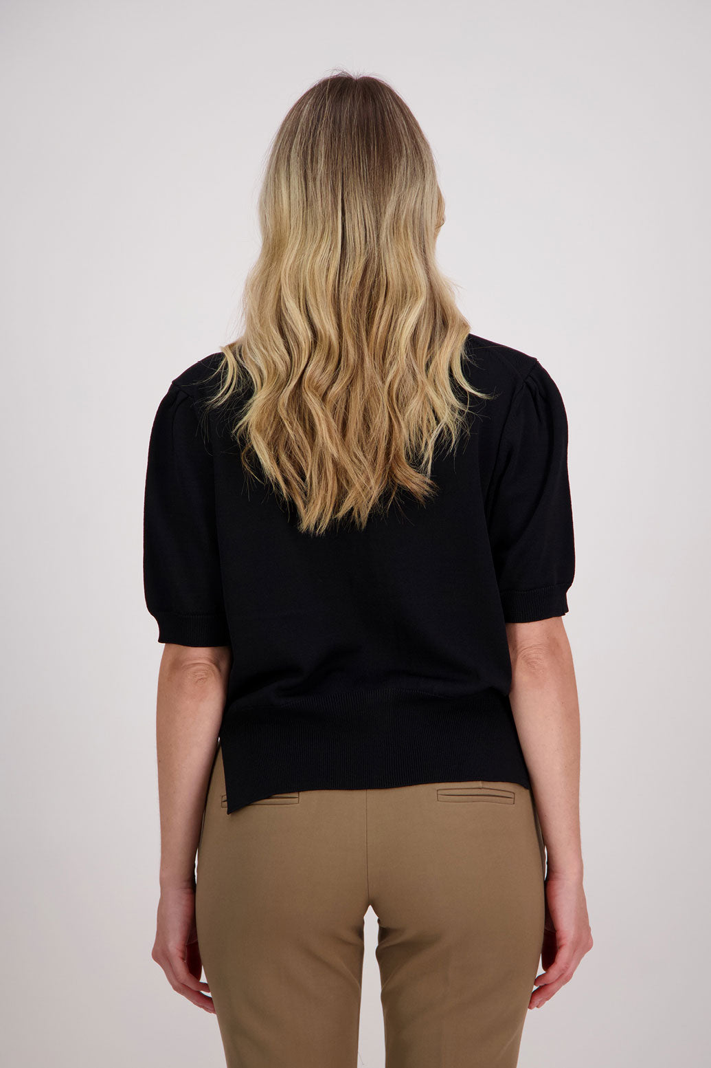 Classic black cardigan with elbow length sleeves, side split hem. Vera