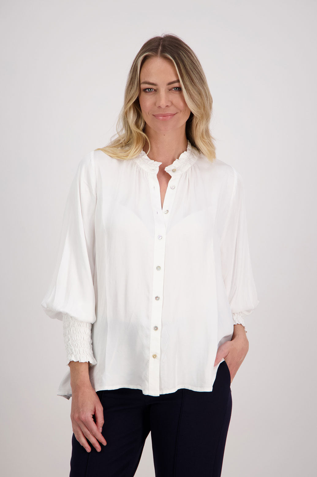 Ivory/White Viscose long sleeve shirt with ruffle collar and shirred sleeves with ruffle. Audrey