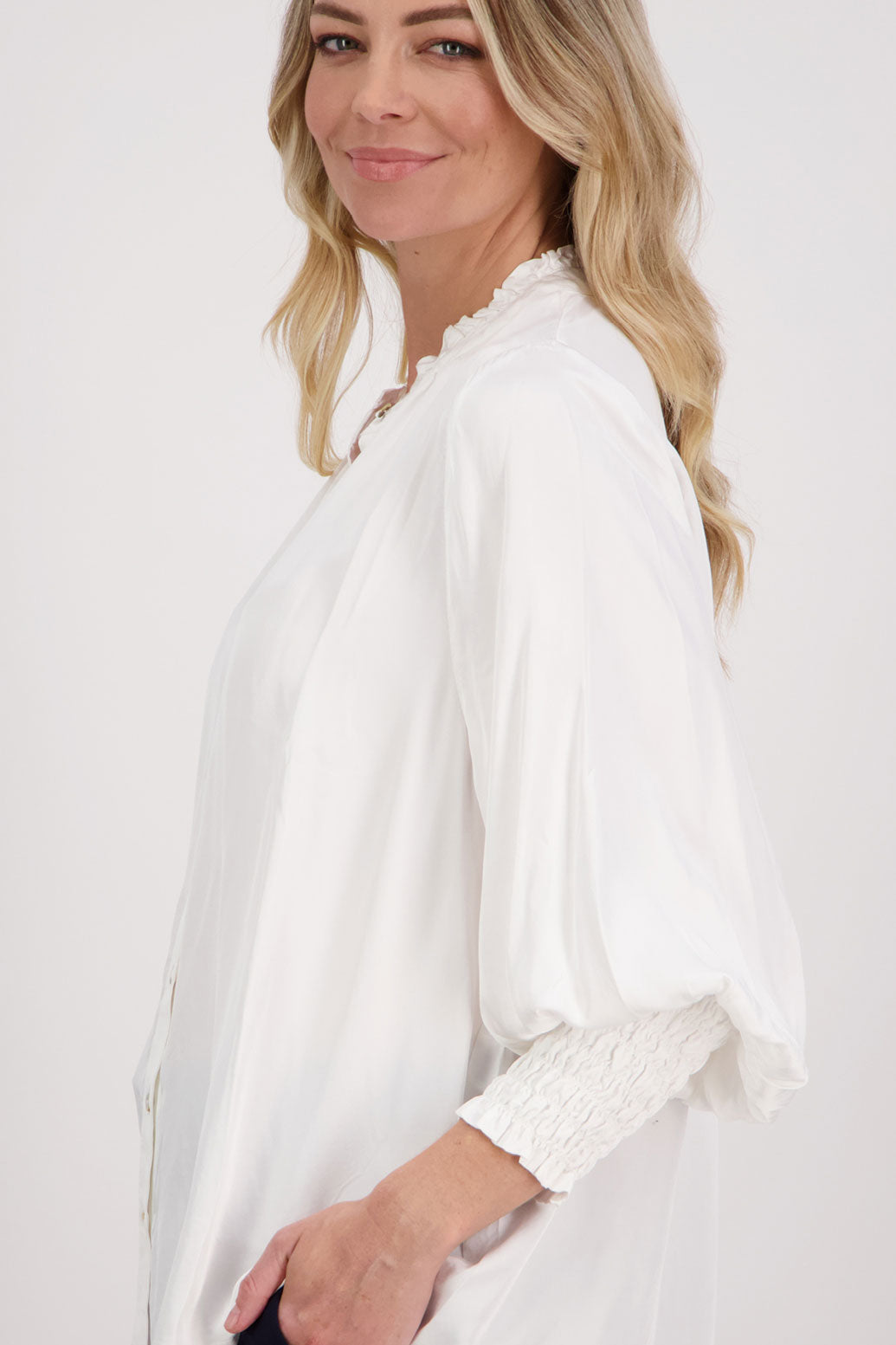 Ivory/White Viscose long sleeve shirt with ruffle collar and shirred sleeves with ruffle. Audrey