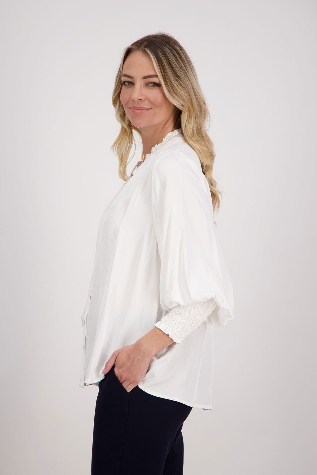 Ivory/White Viscose long sleeve shirt with ruffle collar and shirred sleeves with ruffle. Audrey