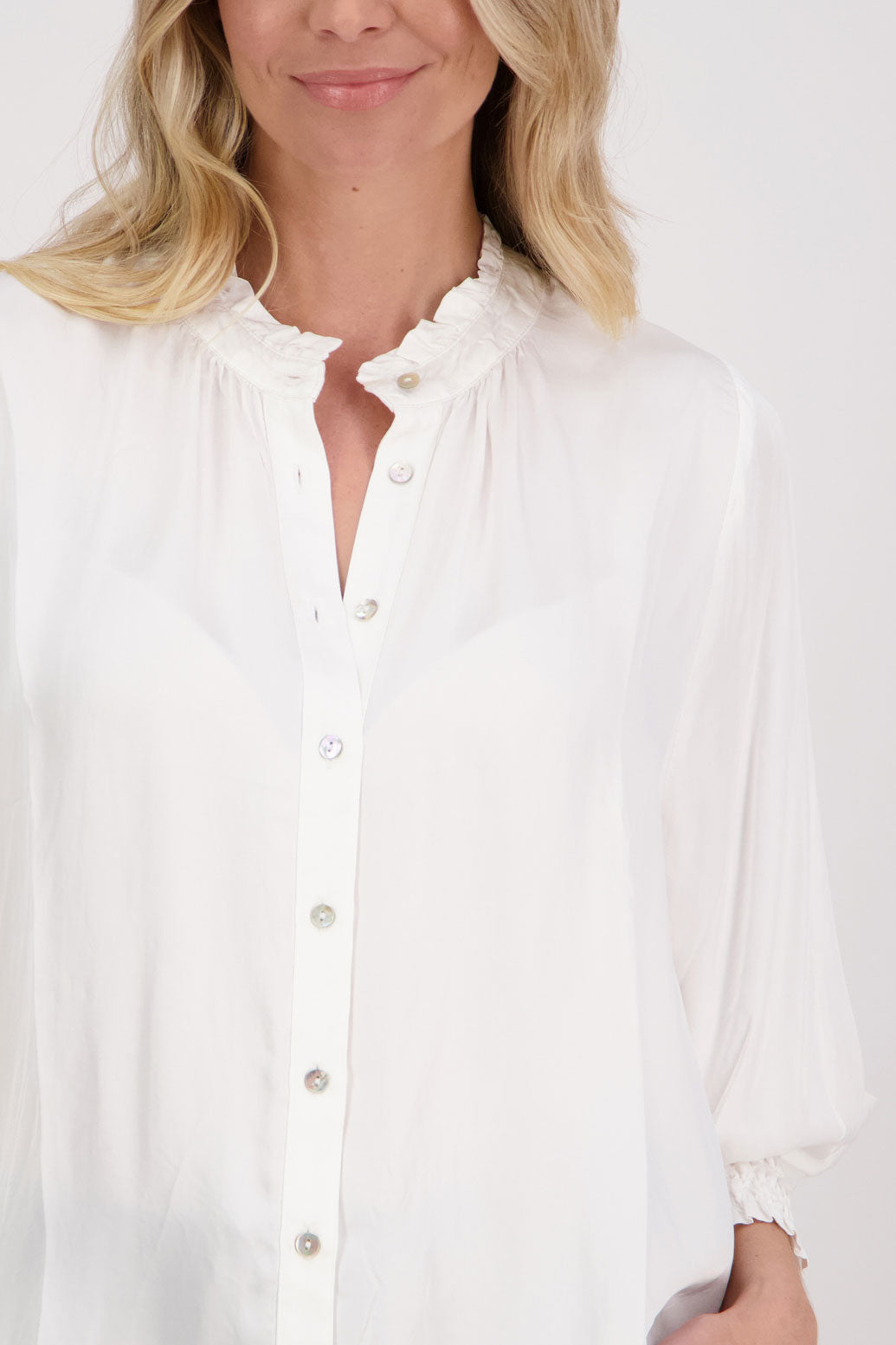 Ivory/White Viscose long sleeve shirt with ruffle collar and shirred sleeves with ruffle. Audrey